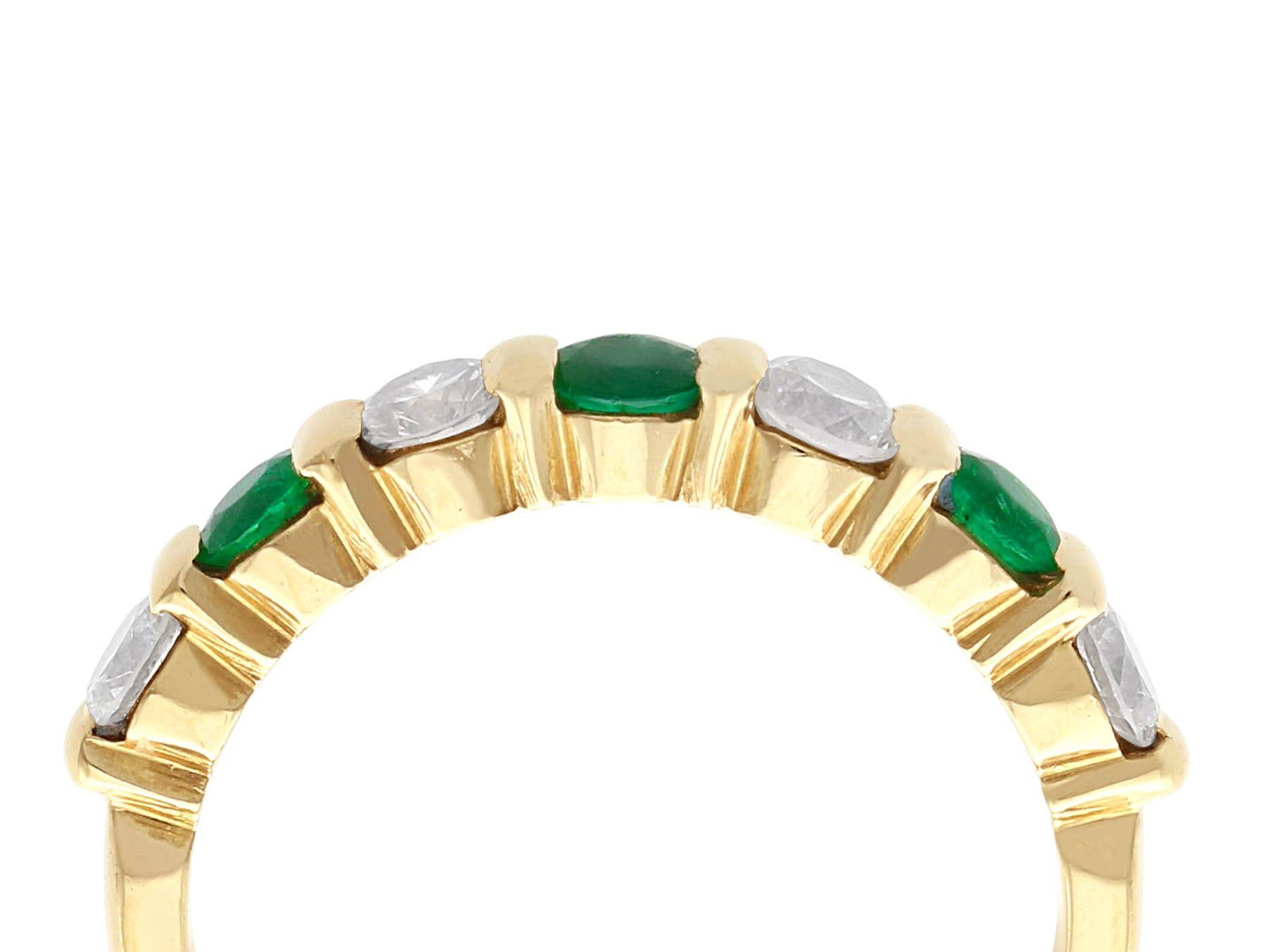 A fine and impressive vintage French 0.55 carat emerald and 0.80 carat diamond, 18 karat yellow gold half eternity ring; part of our vintage jewelry and estate jewelry collections.

This fine and impressive vintage emerald and diamond ring has been