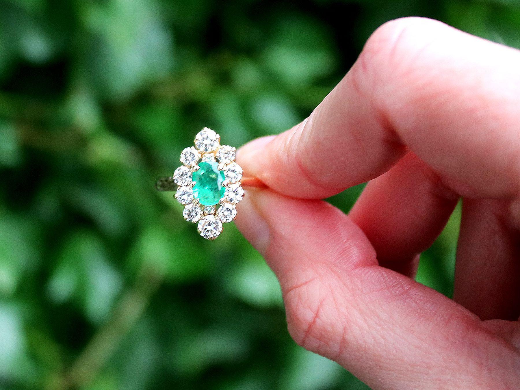 A fine and impressive 0.70 Carat emerald and 0.98 Carat diamond, 18 karat yellow gold dress ring; part of our diverse vintage jewelry and estate jewelry collections.

This fine and impressive vintage emerald and diamond cluster ring has been crafted