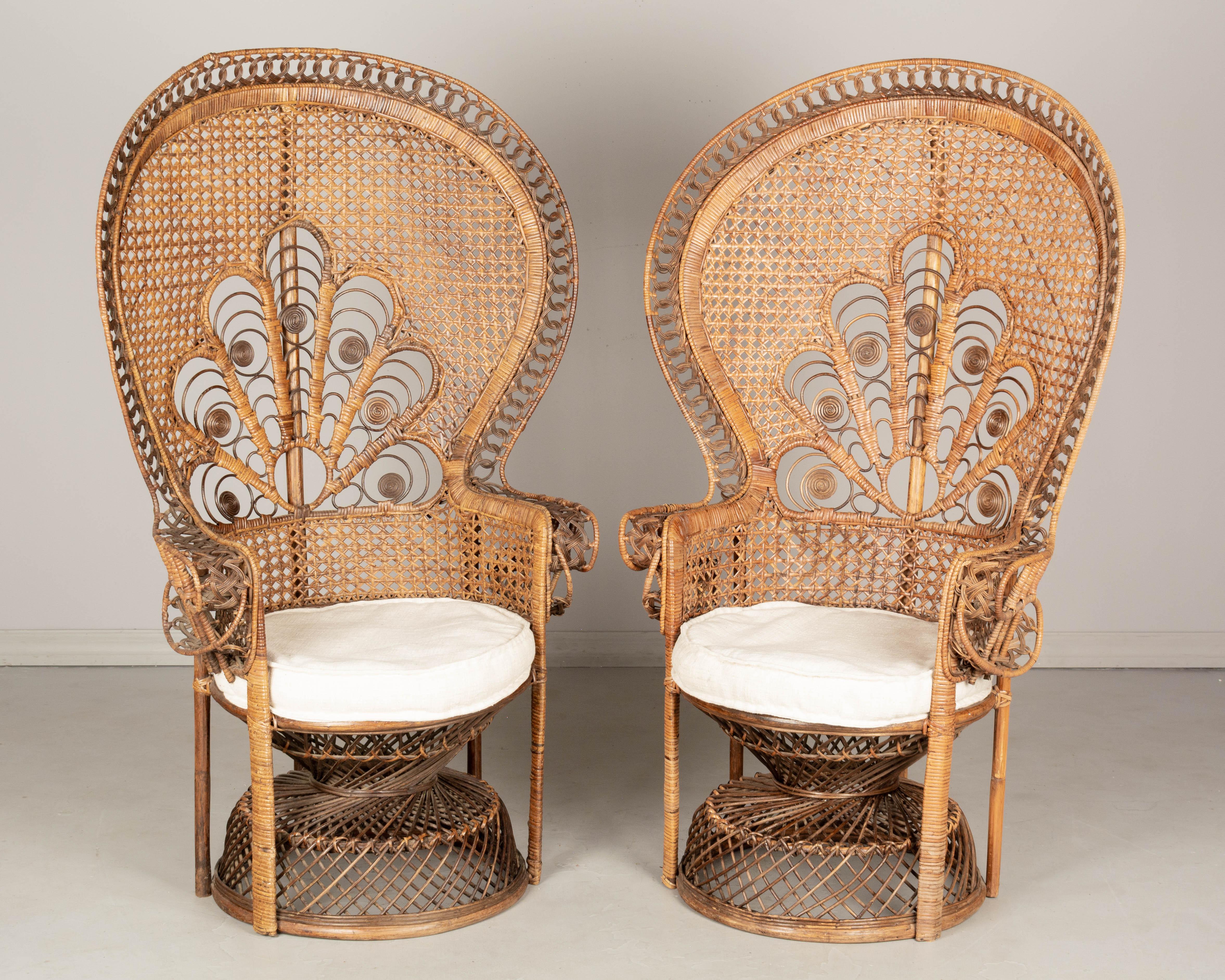 A pair of vintage French peacock armchairs with full fan back, made of handwoven rattan and produced by the French company Kok Maison in the 1970s. Stunning boho chic statement piece, beautifully crafted with intricate detailing, especially in the