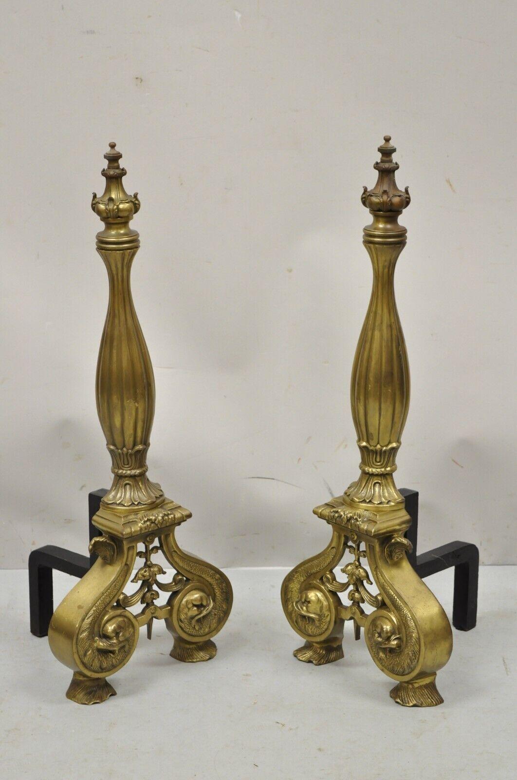 Vintage French Empire Style Dolphin Head Bronze Brass Fireplace Andirons - a Pair. Item features dolphin heads, cast bronze forms, ornate finial, cast iron supports, very nice pair. Circa late 20th century. Measurements: 27.5