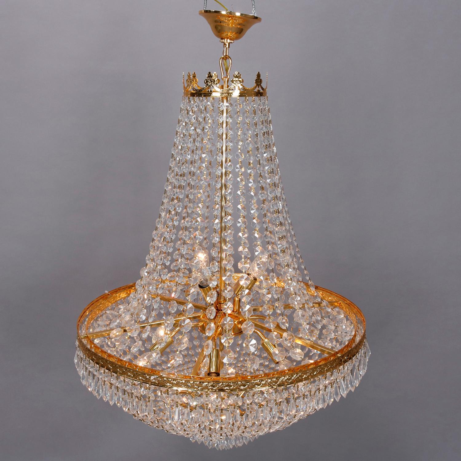 A vintage French Empire Sac a pearl form chandelier offers gold gilt metal frame with pierced crown surmounting strung pearl body housing eight lights, 20th century

Measures: 39