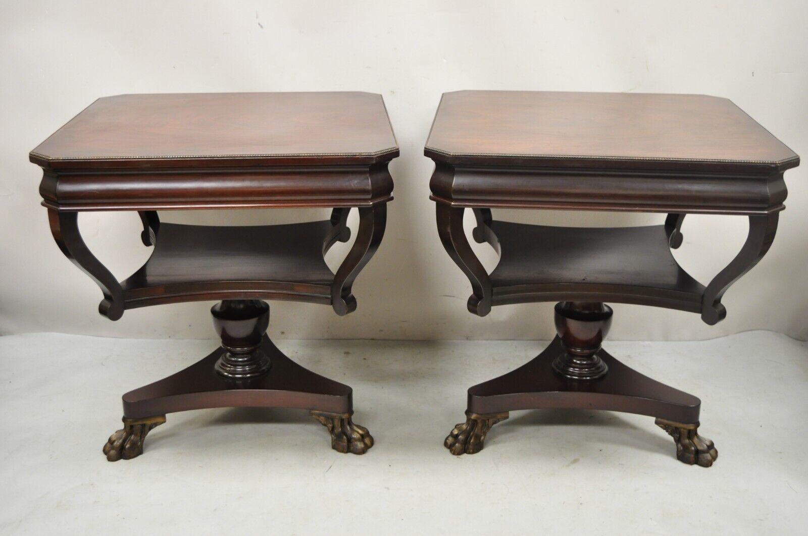 Vintage French Empire Style Mahogany Paw Feet Side Tables - a Pair. Item features a claw foot tripod pedestal base, lower shelf, beautiful woodgrain, very nice vintage pair, quality American craftsmanship. Circa Early to Mid 20th Century.