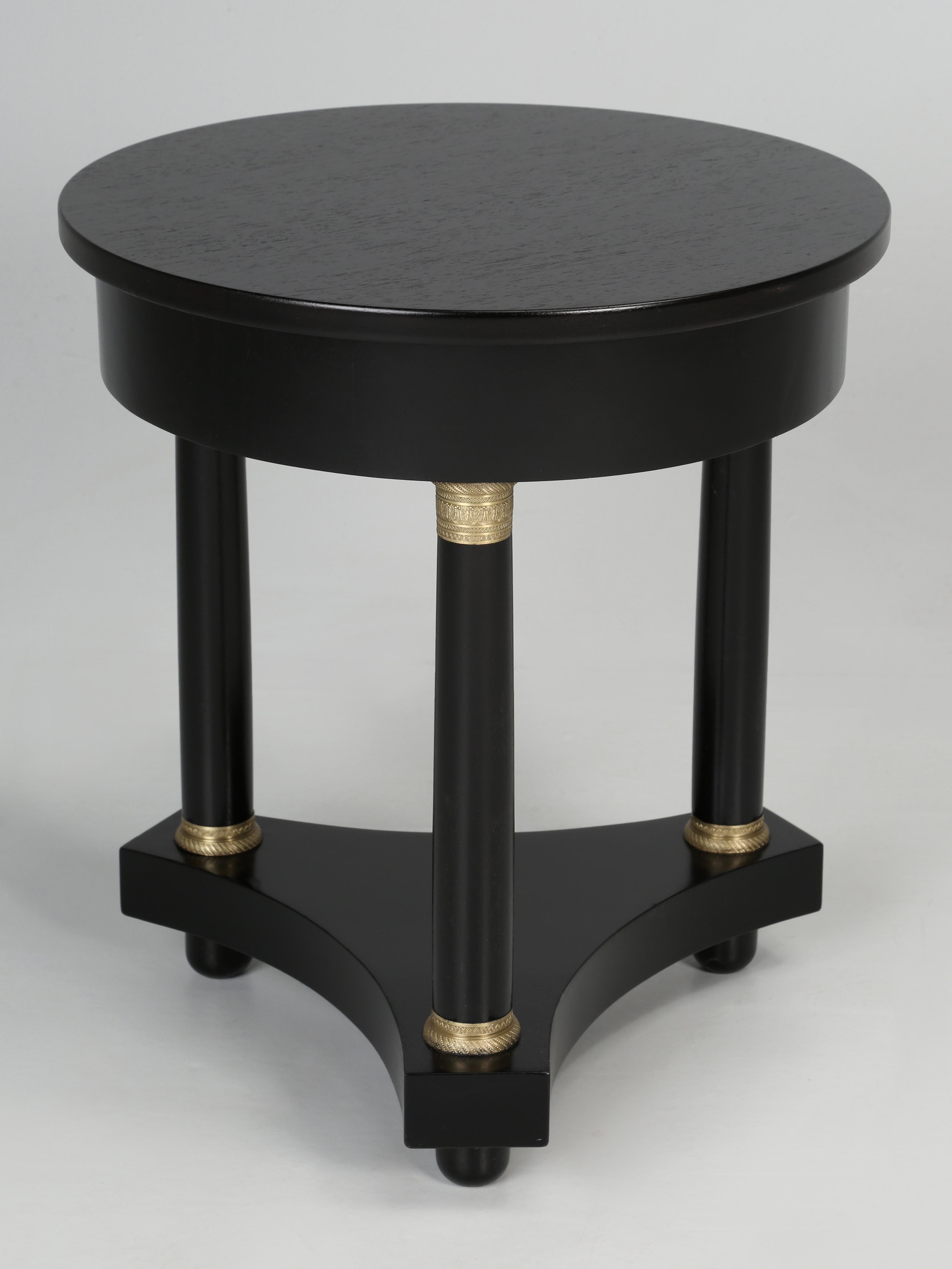 Vintage French Empire side table or Empire end table that was recently restored in our Old Plank workshop. The finishing department hand-sanded and stripped the mahogany, without the use of any harsh chemicals and installed an Old School Ebonized