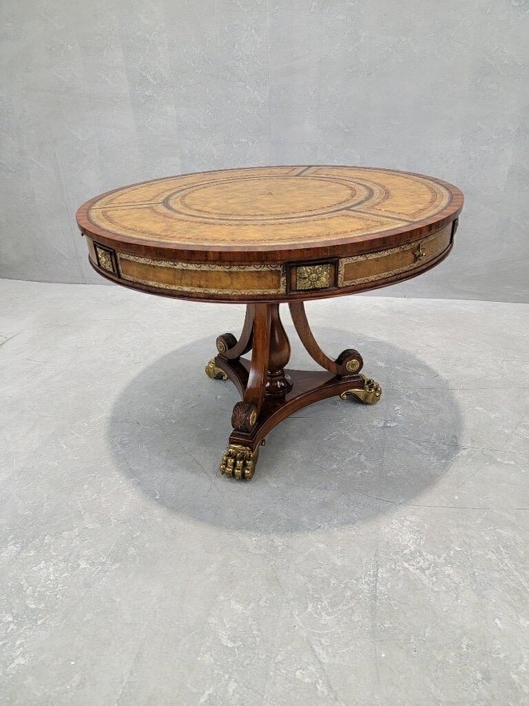 Vintage French Empire Regency Style Tooled Leather Top Mahogany Library/Hall Table by Maitland Smith

Elegant and stunning vintage French Empire Regency style library/hall table by Maitland-Smith. This round mahogany table has a tooled leather top,