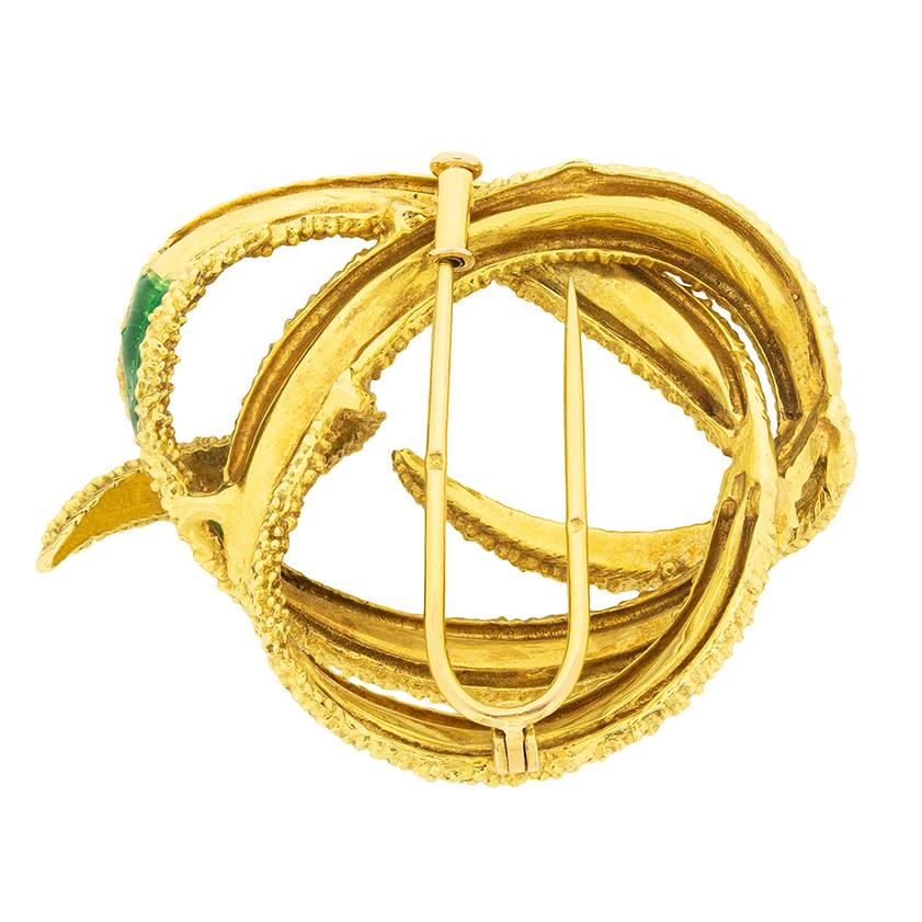 This vintage brooch features two swirling ribbons, coloured by glossy green and blue enamelling. The body of the brooch is made of 18 carat yellow gold. This lovely brooch was made in France in the 1960s.

 

Age: 1960s
Metal: 18ct Yellow Gold