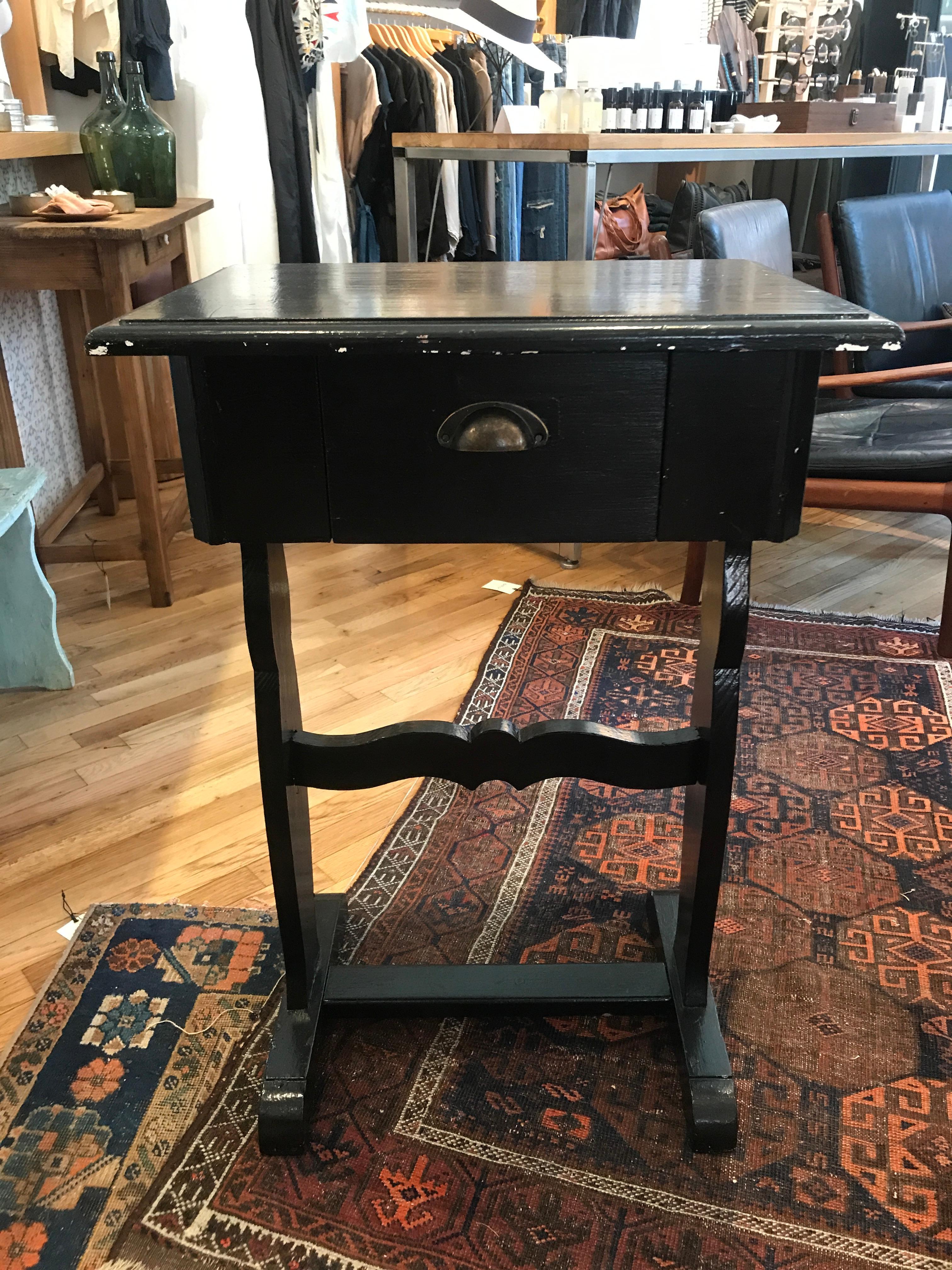 This elegant vintage French end table with a beautifully worn in black finish would be great for a small vanity or entry table. A versatile piece that captures the high style of the French.