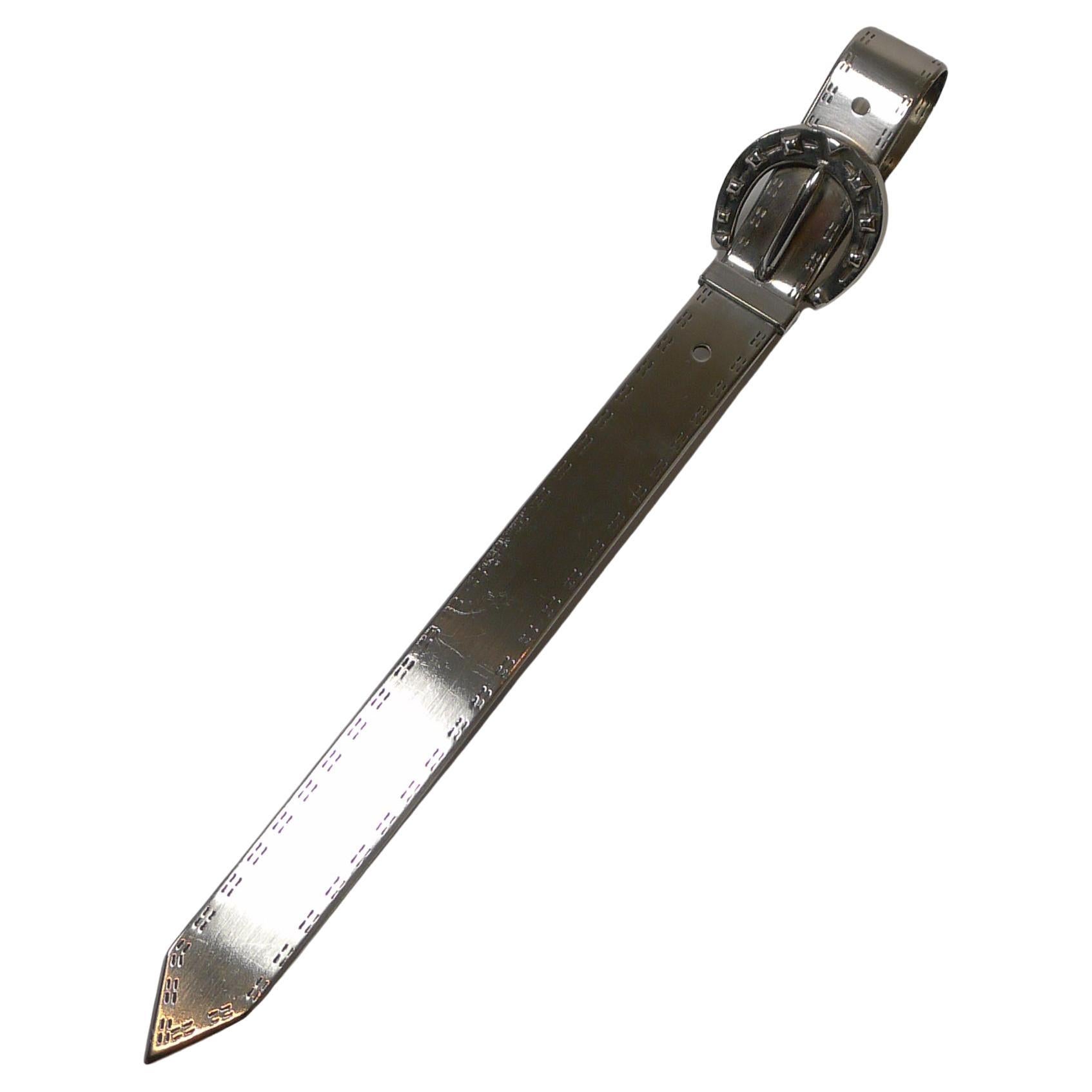 An unusual and highly sought-after vintage silver plated letter opener by the world renowned, Christian Dior.

The letter opener is fashioned in the form of a belt with engraved 