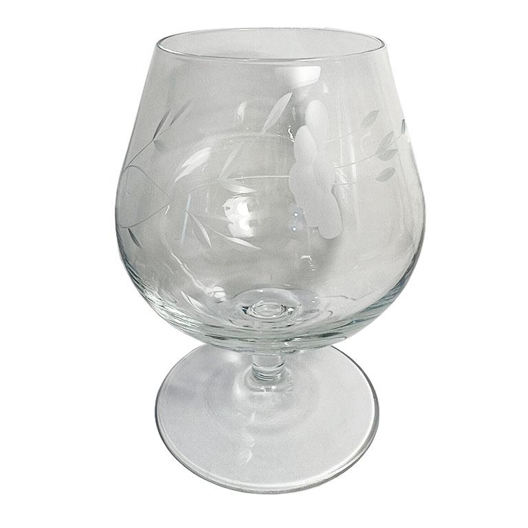 A set of four (4) etched crystal brandy sniffer glasses from France. The body of each piece is etched with a bouquet of flowers, and the bottoms are each stamped with 