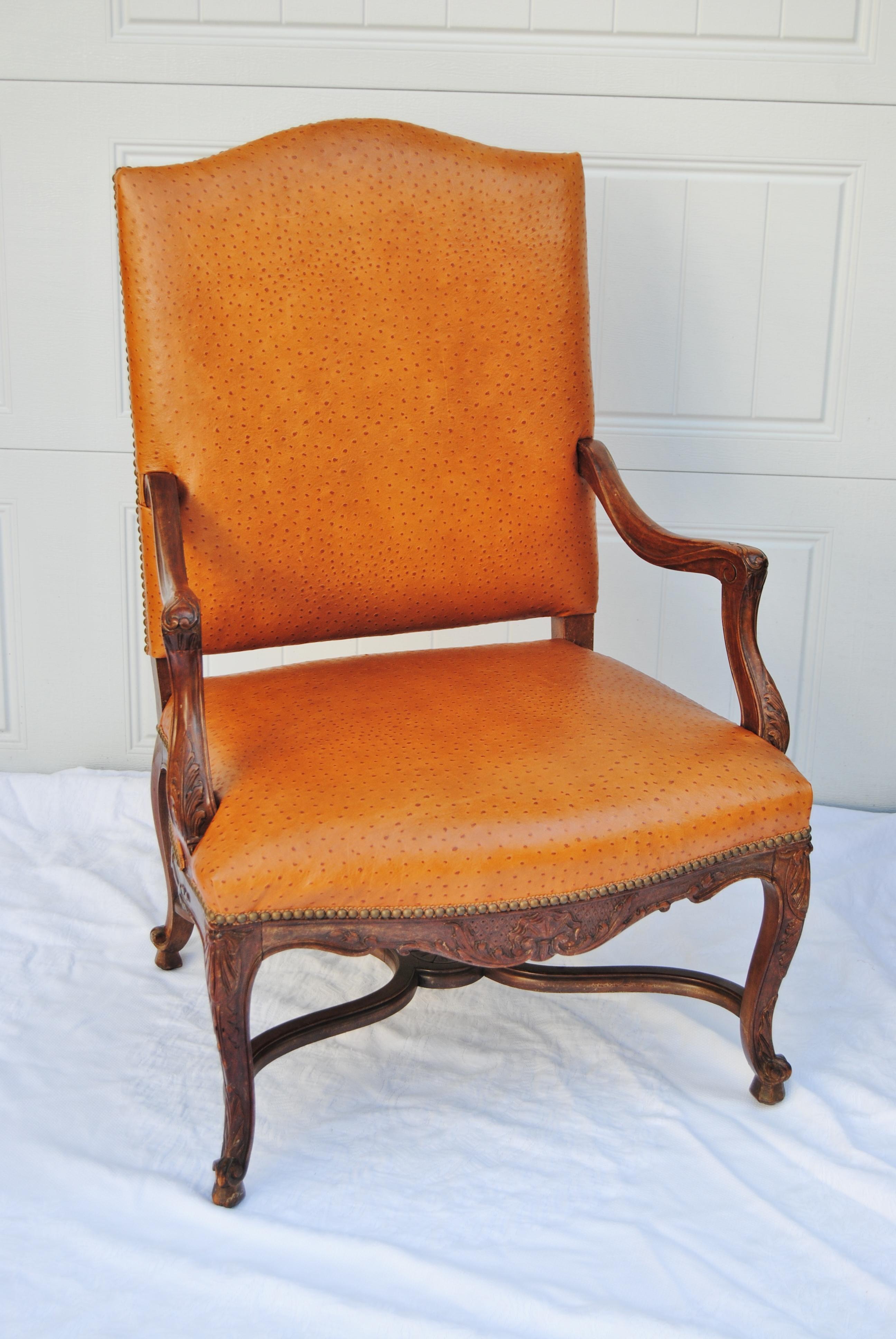 Vintage French fauteuil newly upholstered in Edelman faux cowhide leather. Chair is finished with antique gimp and nailhead trim. This is a heavy chair with hand carved apron. It is in good condition with original finish.