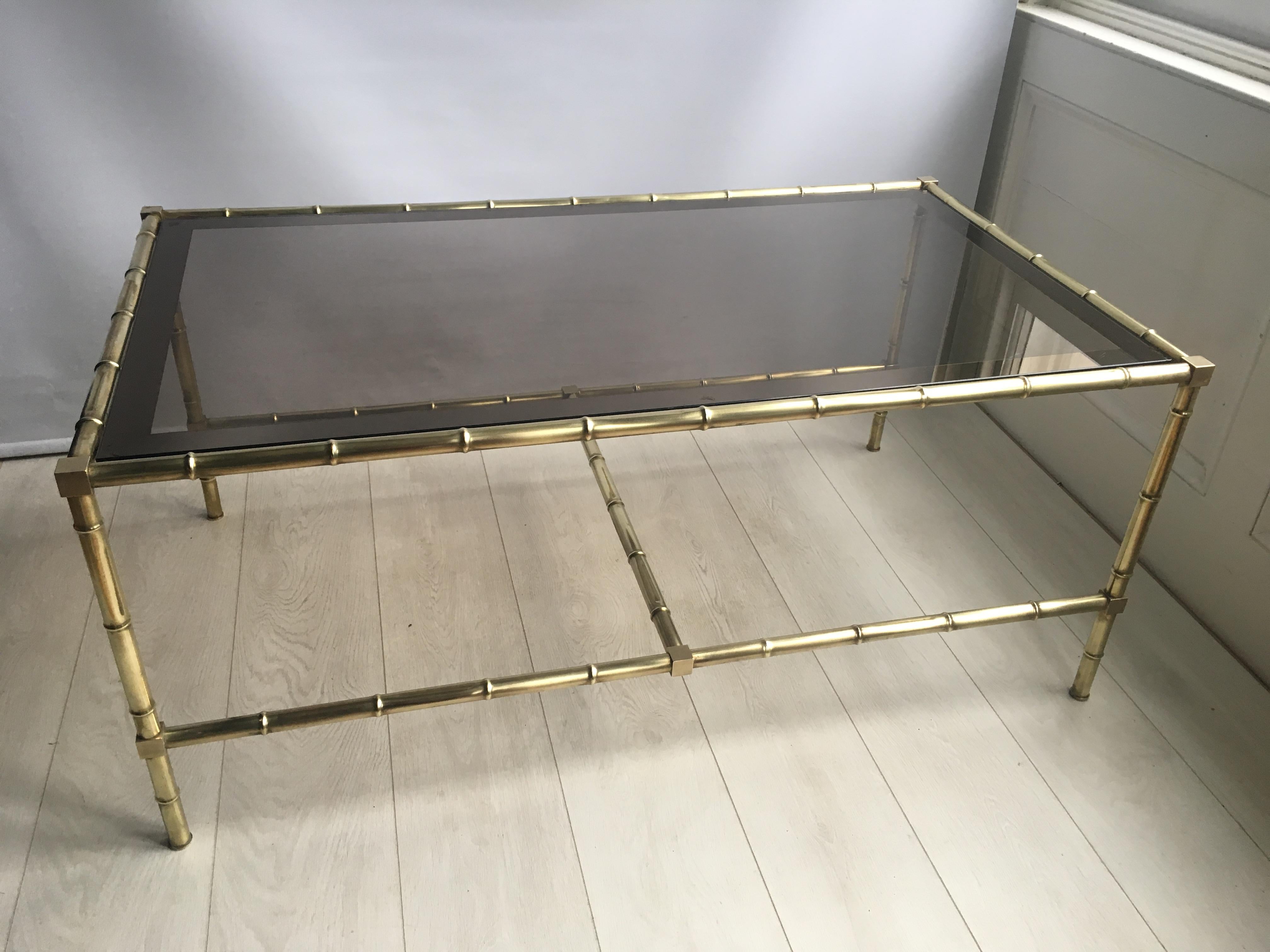 Fantastic faux bamboo coffee table from France, circa 1970

Polished brass frame with original tinted glass top

Great size at 115.5 cm by 65.5 cm and stands 50 cm tall.