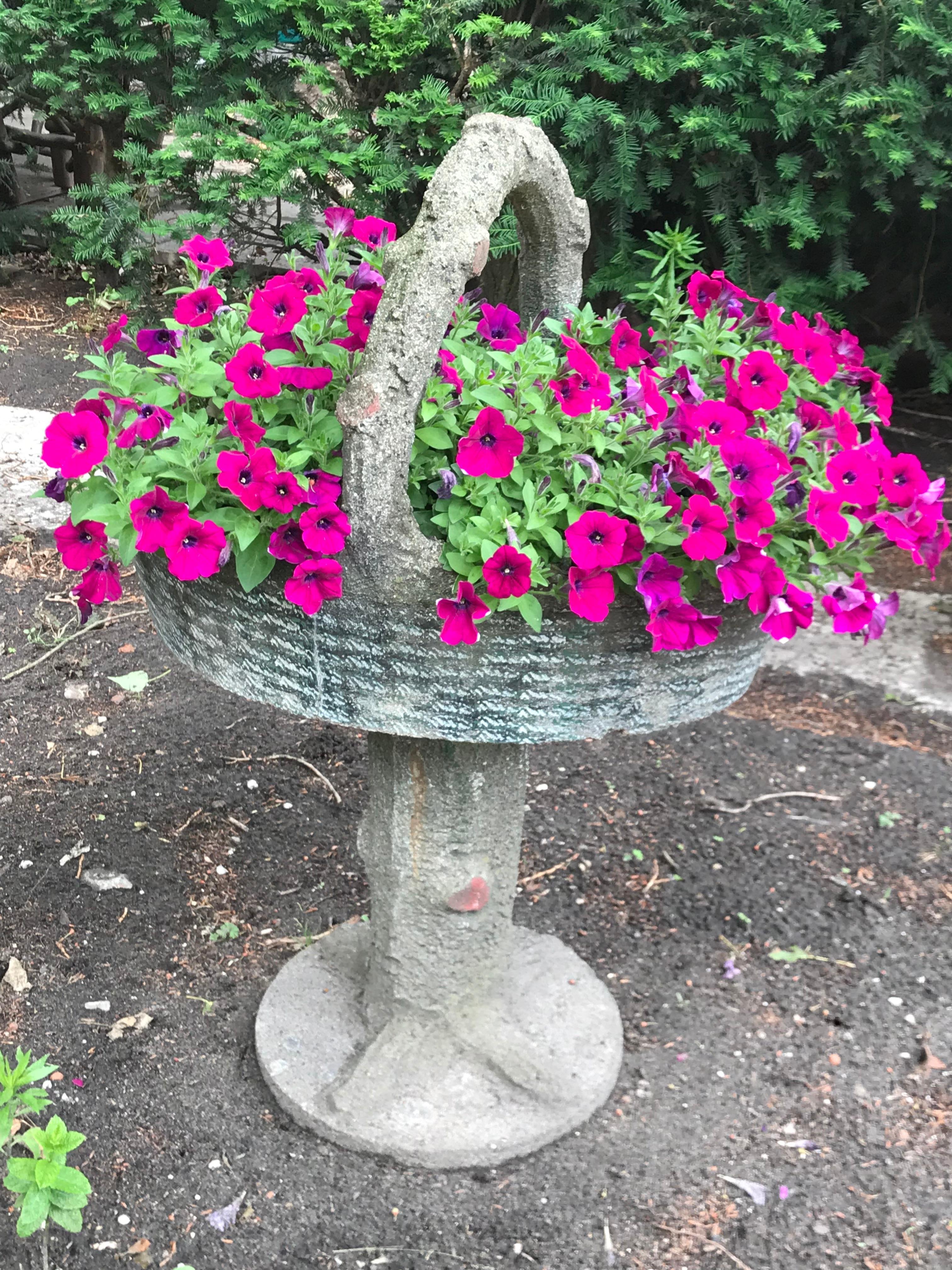 Large faux bois basket on a stand that could be used as a planter, bird bath or fountain.
In good condition; the basket is removable and sits securely on the faux tree base (secured in the center with an iron pin). Such a wonderful piece of
