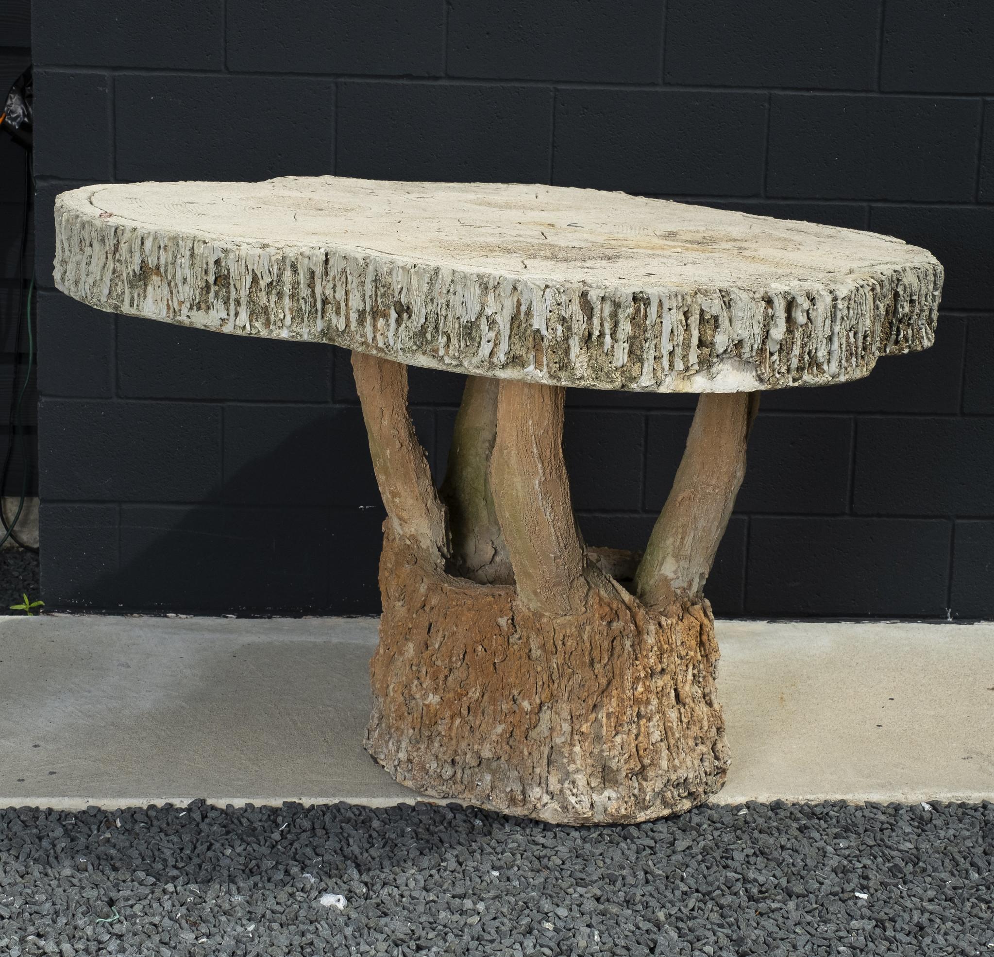 A massive vintage concrete faux bois garden table. Incredibly life-like bark is featured on this rustic French table. This lovely table is constructed in a one piece whimsical manner and has a 5