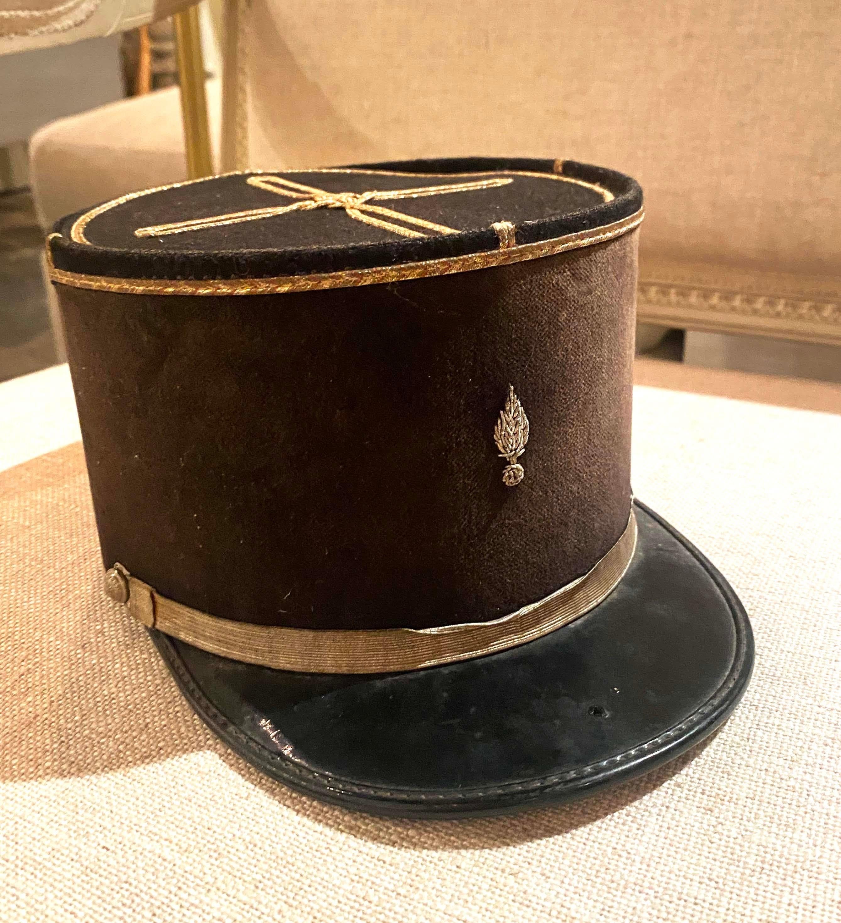 This is a vintage French Kepi/Hat was acquired on a buying trip to France in 2019. In black felt with black plastic peak, gold braid. Made by Balsan Paris, as printed to the interior of the top. Gold braid runs around the top of the Hat with a gold
