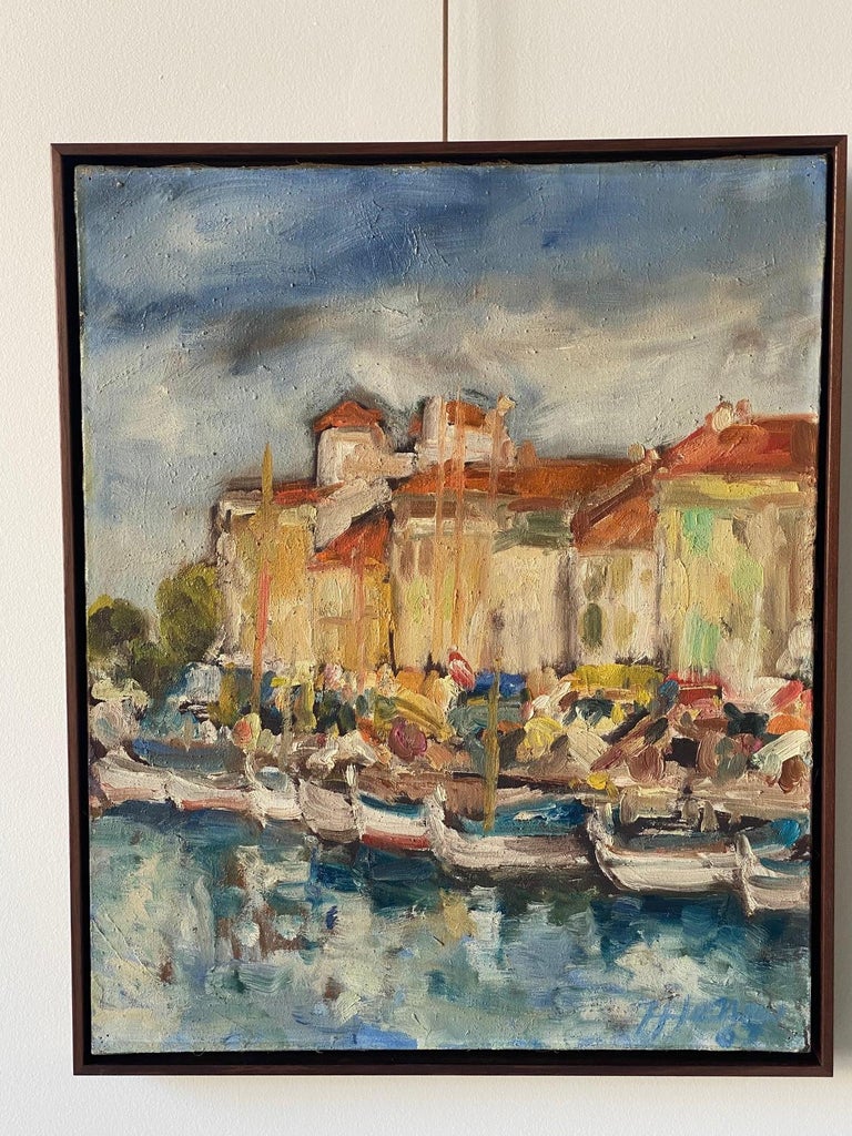 Beautiful original painting of a French seaside fishing village. Newly framed in a walnut floater frame.