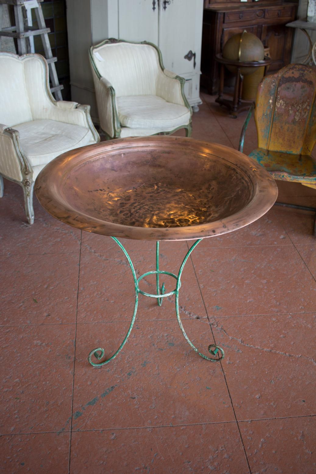 Vintage French garden planter or birdbath. The bowl is beaten copper which sits on a 3-legged scrolled base with original paint residue.