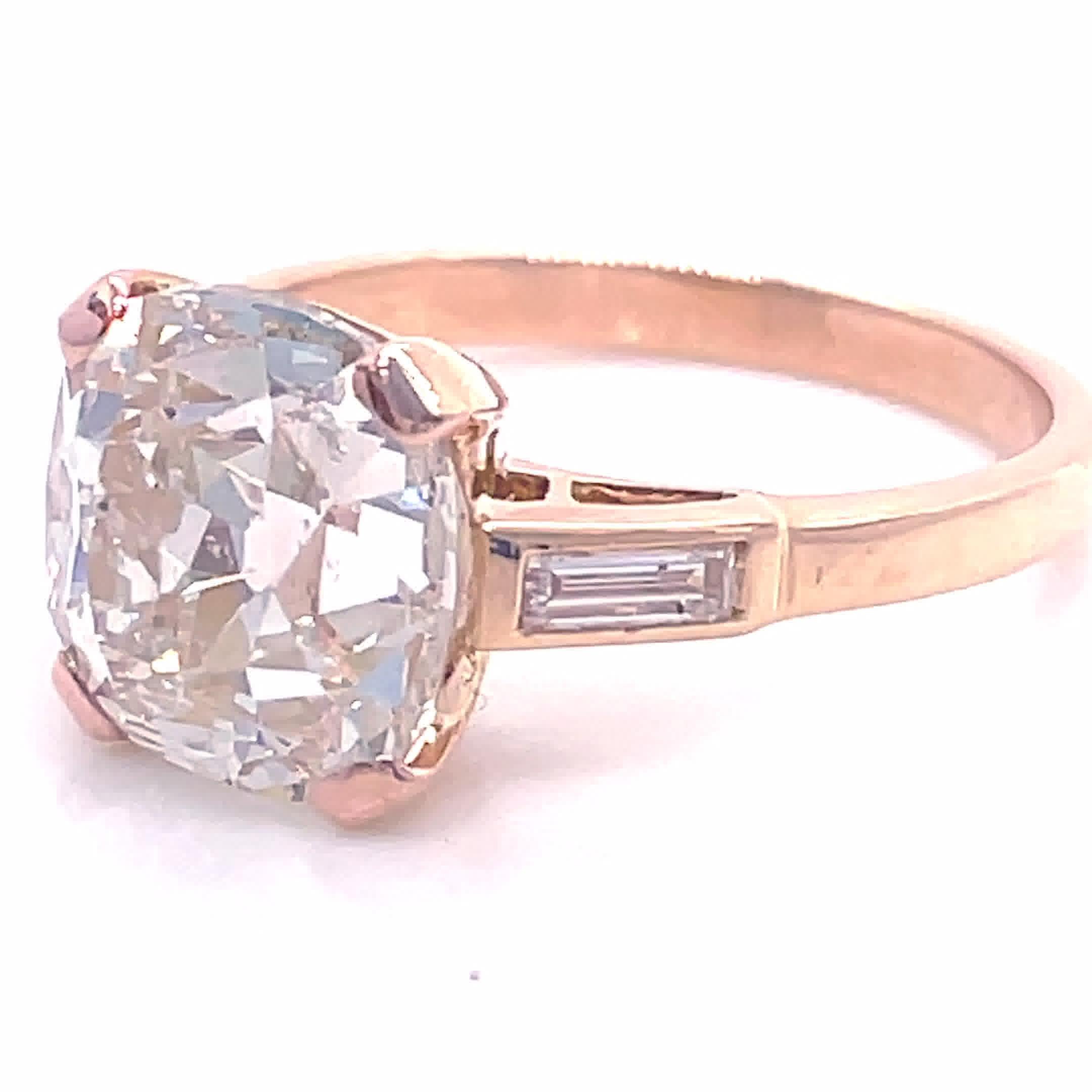 You will win a heart with this timeless, classic vintage engagement ring, and we think you'll agree that it's absolutely breathtaking! The center diamond is an Old Mine Cut, 4.00 carat, M color, I1 clarity (#1216467089). Accented by 2 baguette cut