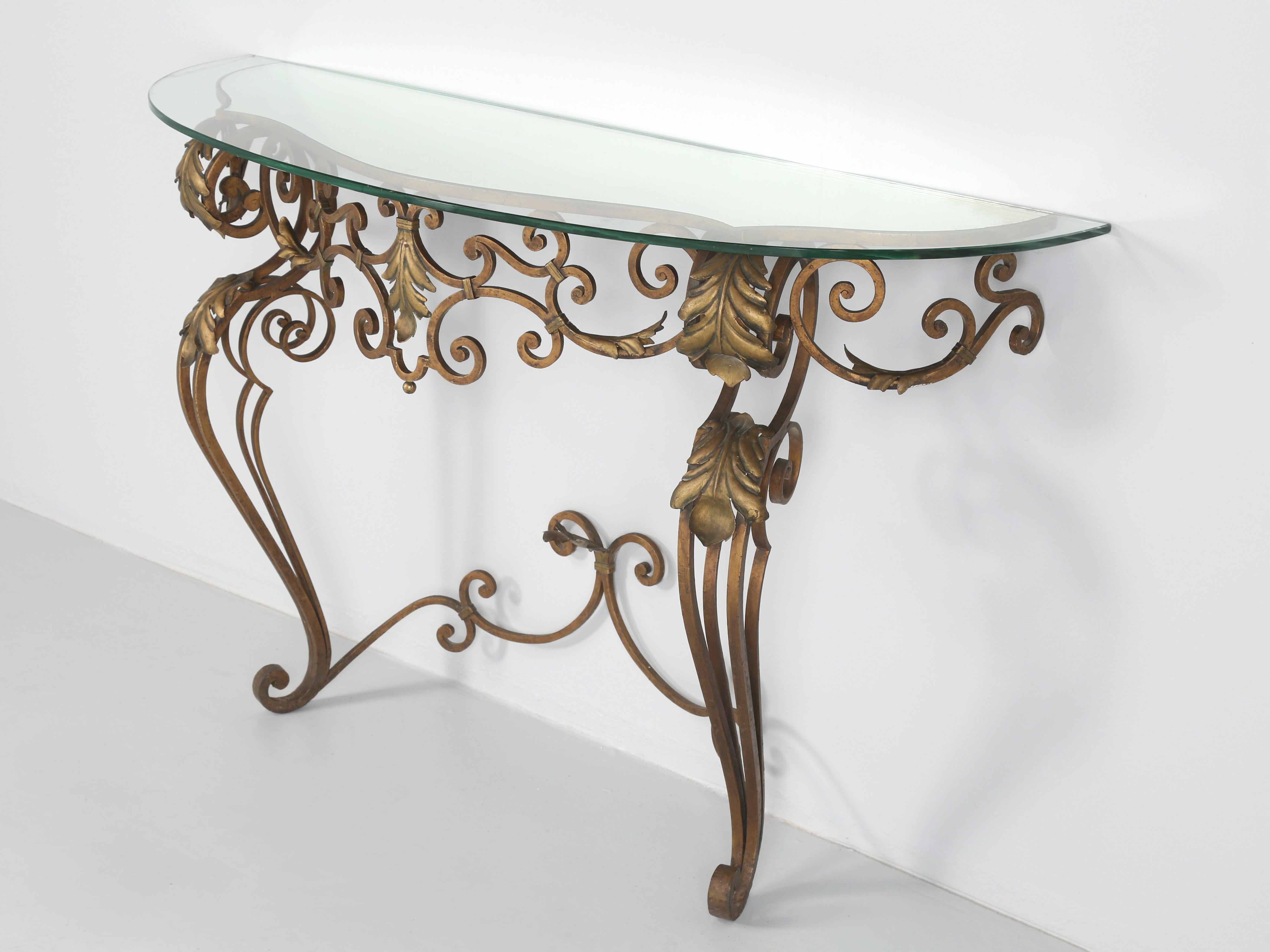 Vintage French Art Deco style wrought iron console table from the 1930’s to 1940’s. Before you read any further, this vintage French wrought iron console table will require a new top, for someone, whom we will not mention broke the glass. The