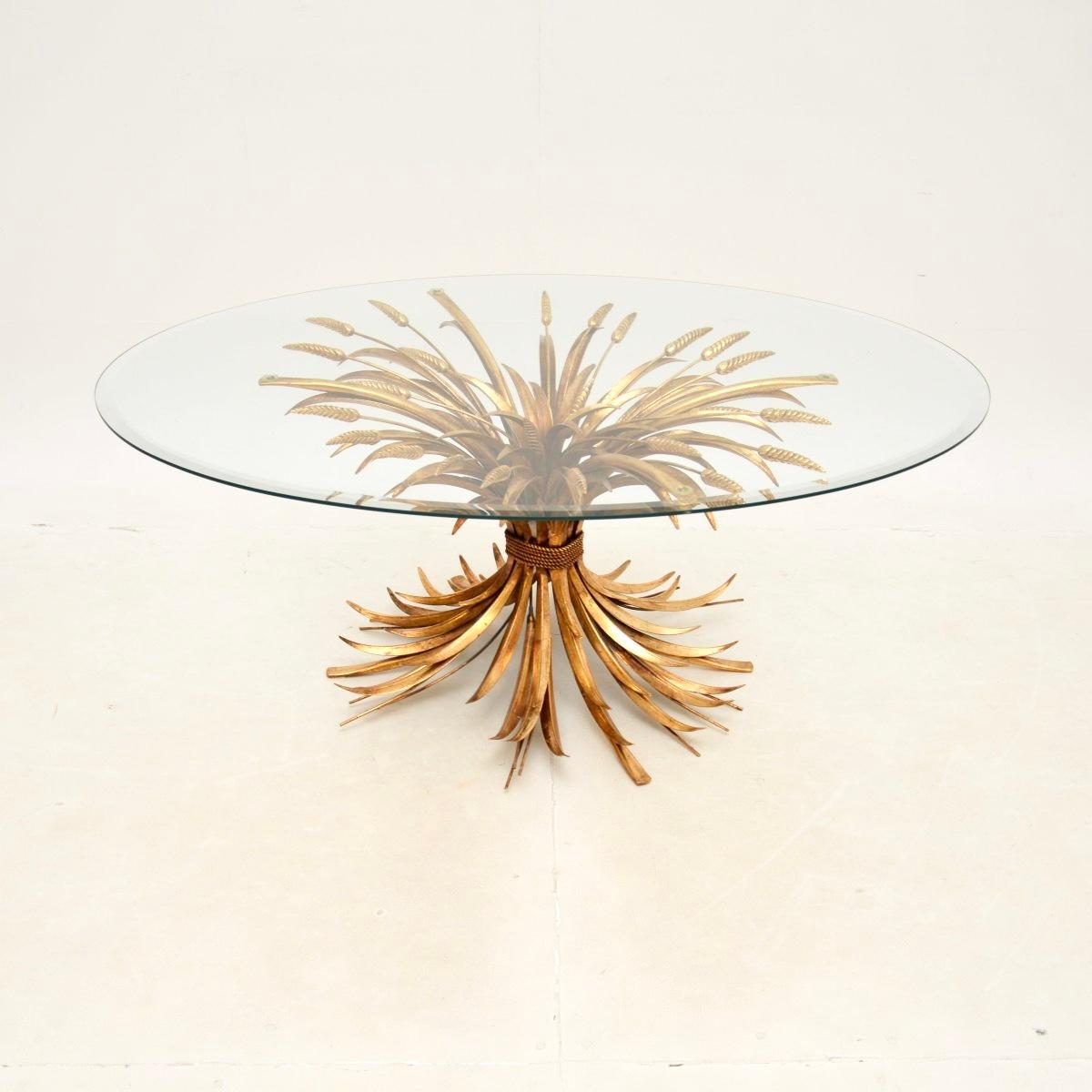 An absolutely gorgeous vintage French gilt metal wheat sheaf coffee table, dating from the 1950’s.

This is a rare large version, the base is wide and impressive, it holds a large clear oval glass top with a bevelled edge.

It is an iconic and