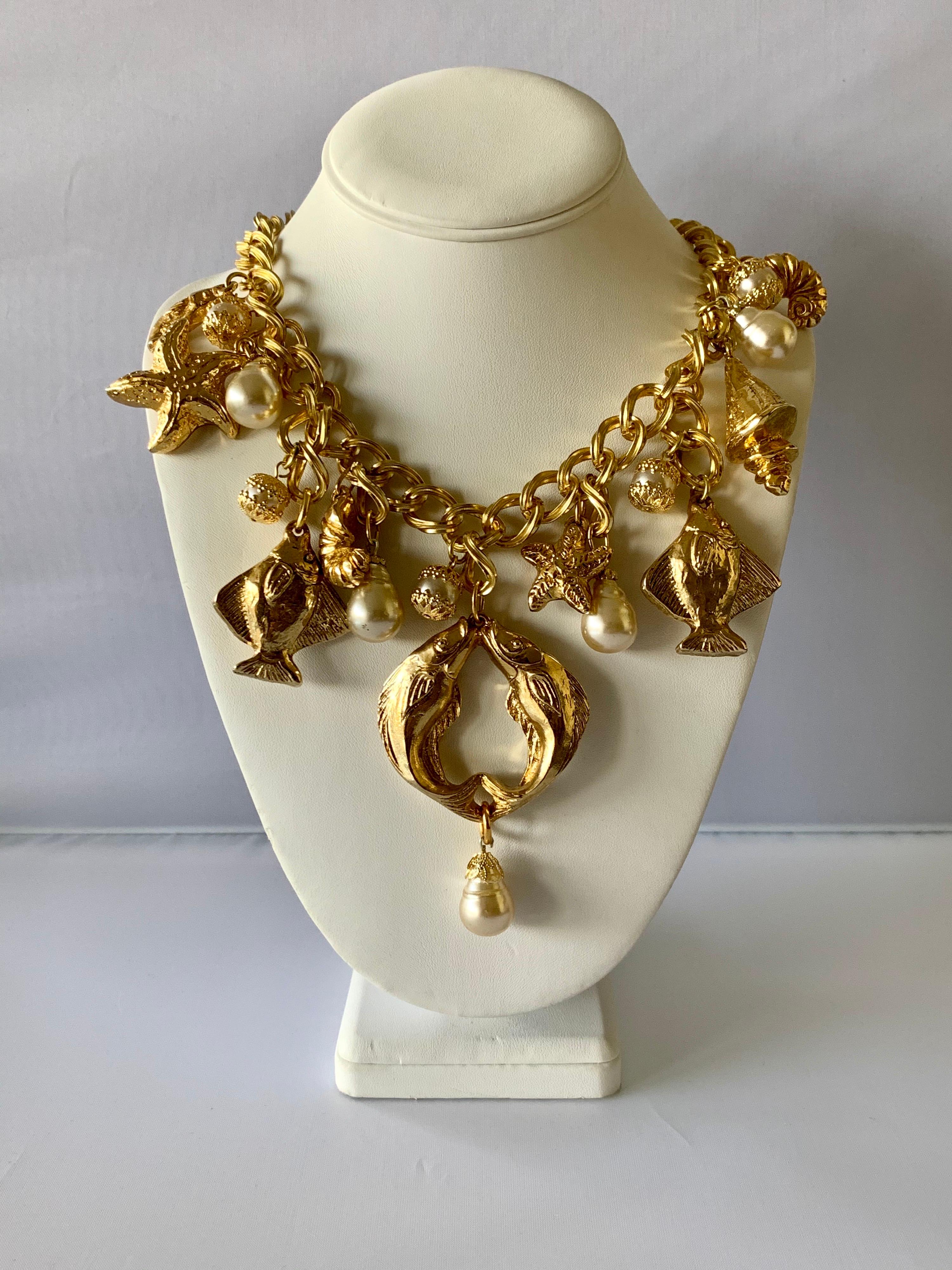 Vintage French nautical charm necklace, comprised out of a thick gilt metal chain adorned by a plethora of fish, seashells, and pearls circa 1980 by Chantal de Kerouartz. The necklace is also featured in the August issue of Vogue Spain.