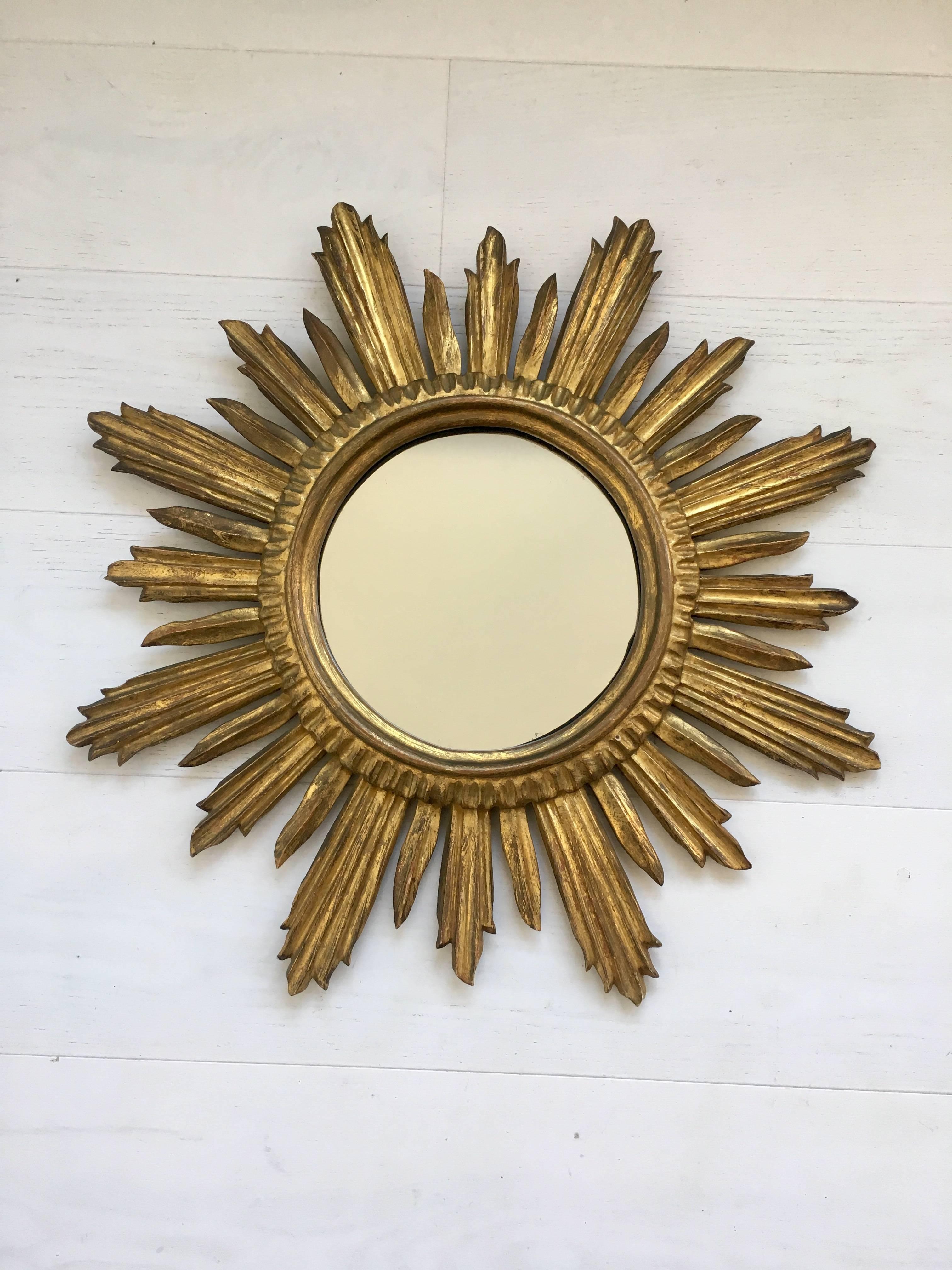 Beautiful coloring and shape to this sunburst mirror, circa 1950

Measures: 55.5 cm across, mirror 22 cm.
     