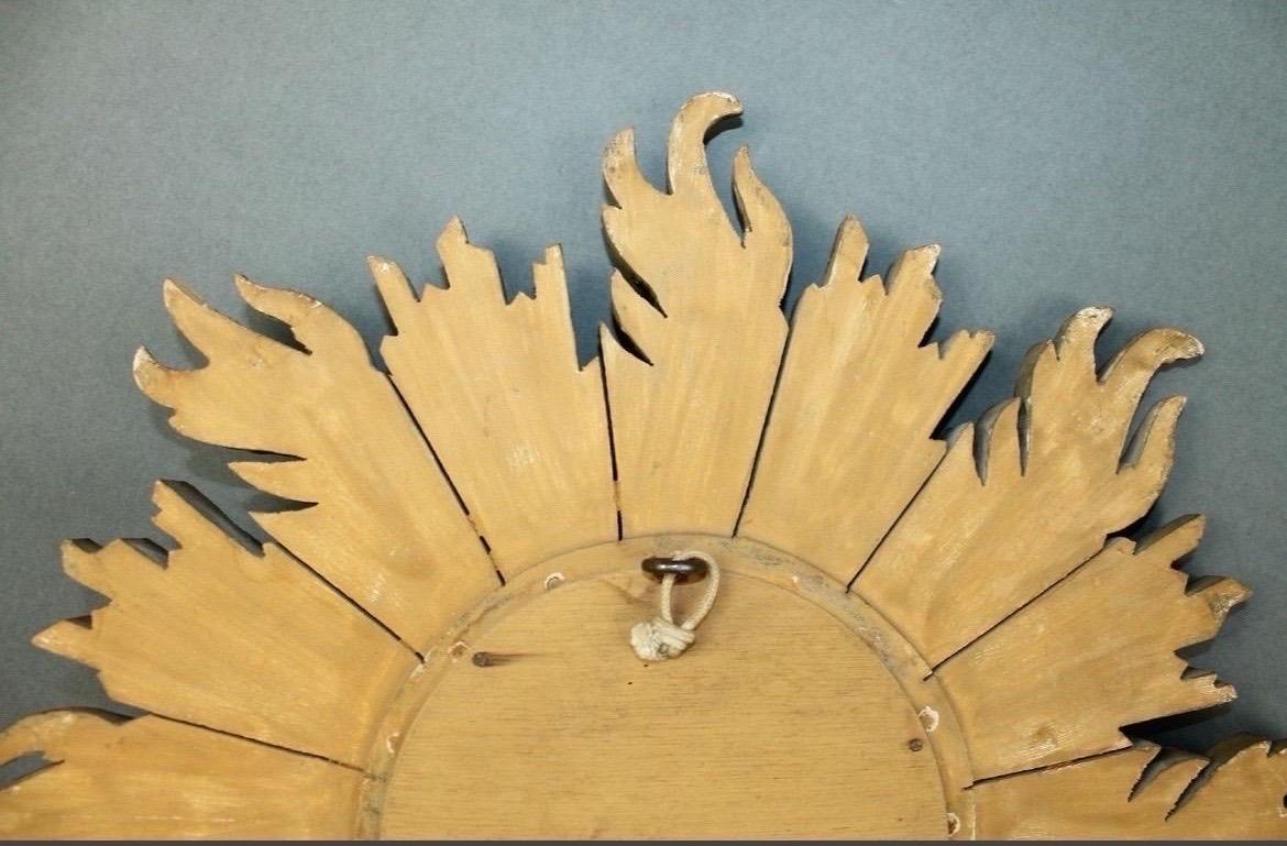 Vintage French giltwood sunburst mirror with convex glass measures 16.5 inches in diameter and weighs approximately 3 lbs. It is a beautifully hand-carved and painted giltwood. 