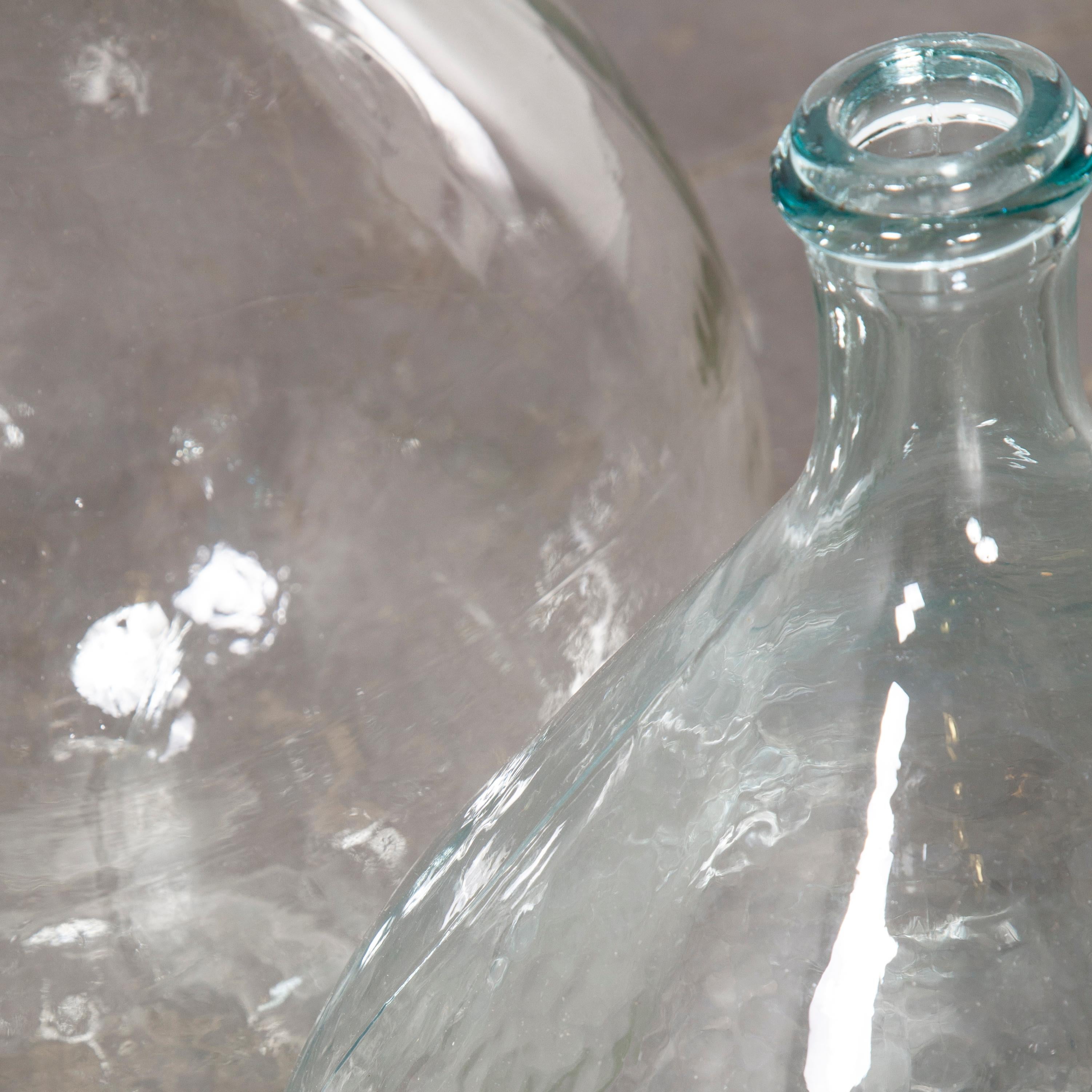 Vintage French glass demijohn, pair of demijohn (Model 957.13)

Vintage French glass demijohns. Pair of mouthblown glass demijohns used as a traditional containers mainly for wine storage and transport. Our demijohns have been carefully cleaned.