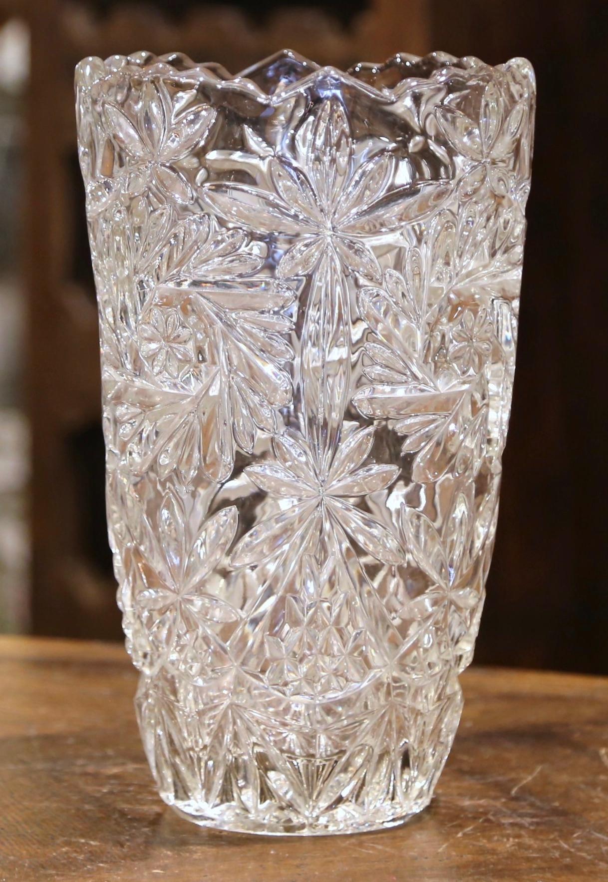 Decorate a console or buffet with this elegant glass vase. Crafted in France, circa 1970 and round in shape with a ridged and scalloped rim, the large luxurious cut glass vessel is decorated throughout with etched floral motifs. The tall and thick