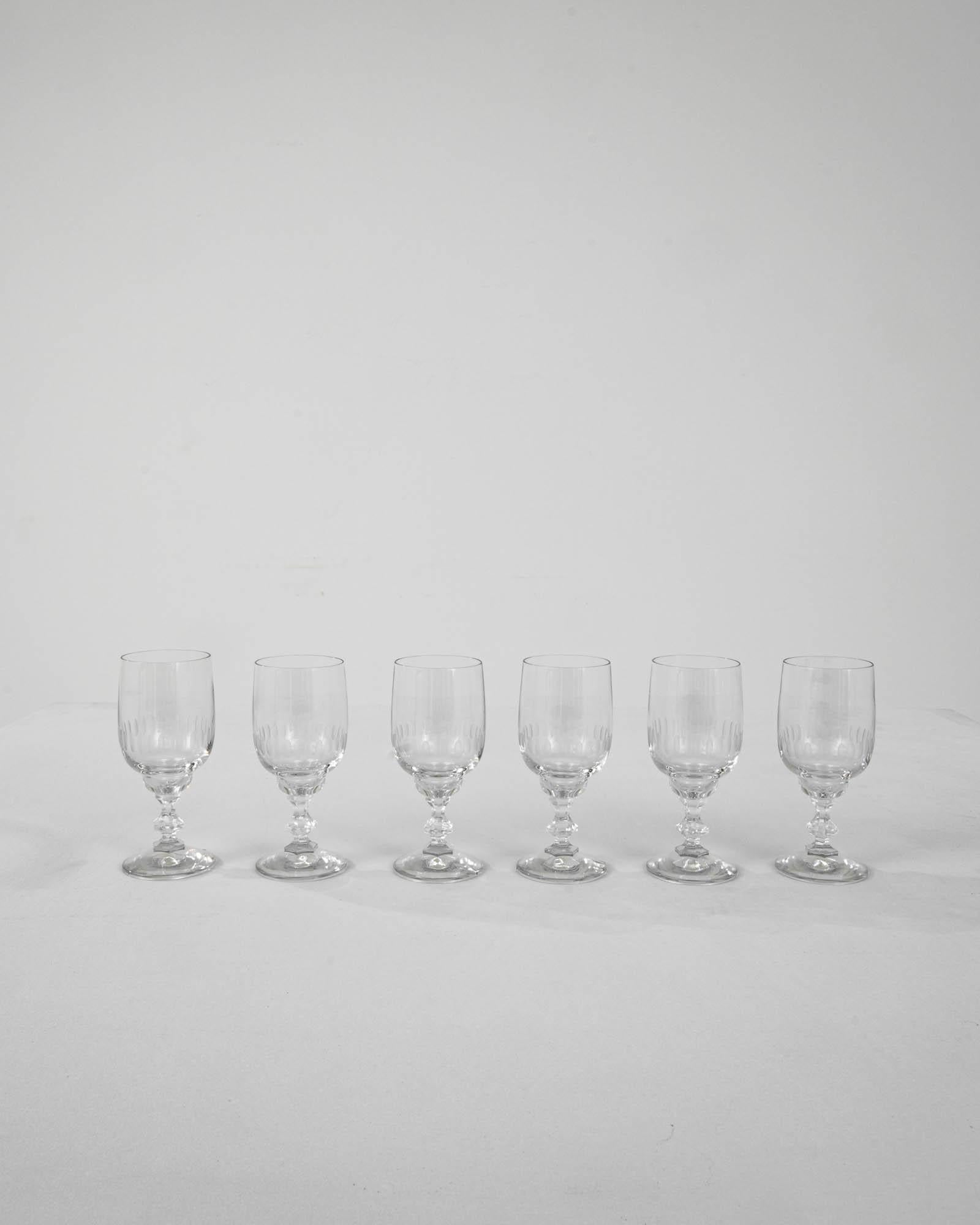 A set of vintage cut crystal glasses from France. Their petite size indicates they were intended for holding fortified wine, such as port or lillet– this French classic would typically be served as an aperitif. The elegant design rests on an