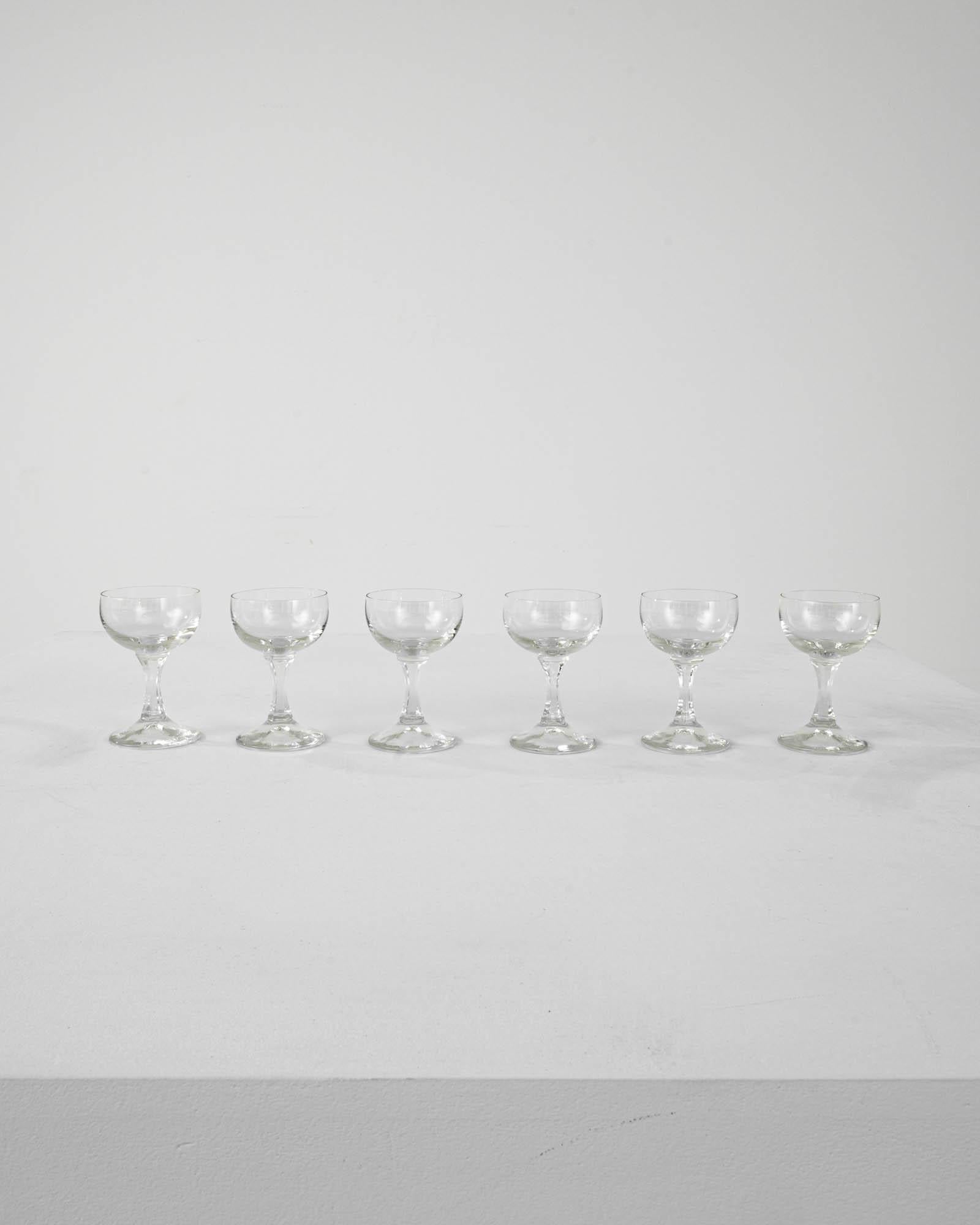 A set of vintage cut crystal glasses from France. Their petite size indicates they were intended for holding fortified wine or spirits, such as port or lillet– this French classic would typically be served as an aperitif. The elegant design rests on