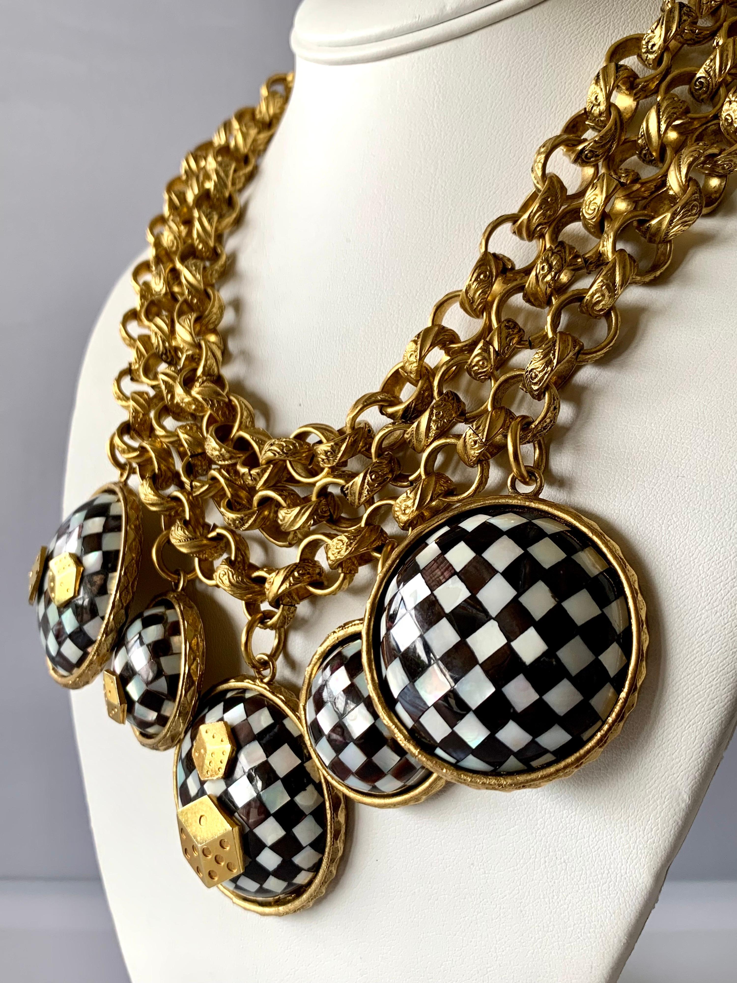 Vintage Mercedes Robirosa chunky three-dimensional gold-tone statement necklace featuring large round checkered mother of pearl charms embellished by gold dice - made in France. 

Note: The necklace has a wearable length of up to 18 inches.