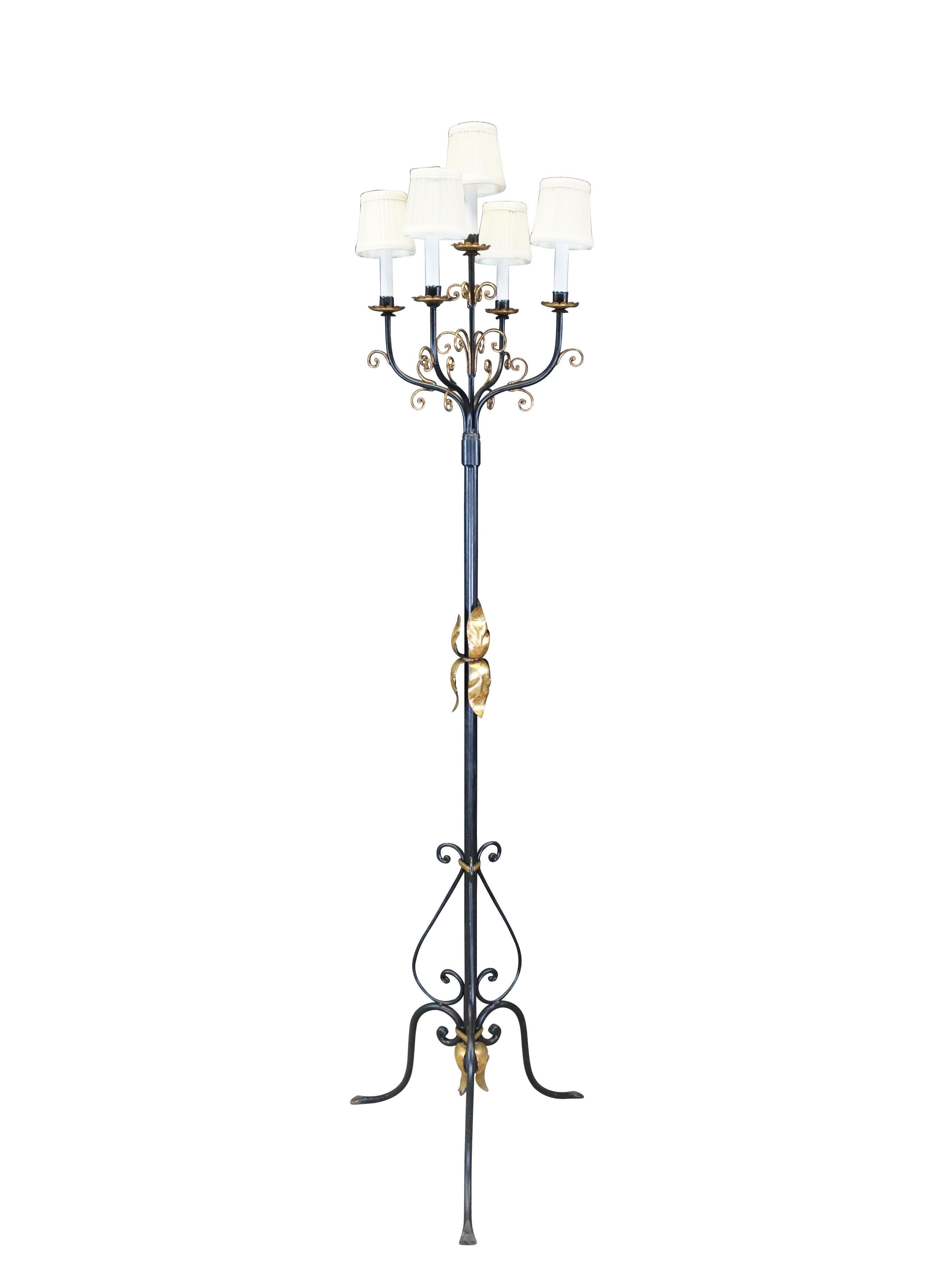Tall vintage French Gothic Revival five light floor lamp featuring scrolled black iron with gold acanthus accents and a five arm candlestick candelabra.