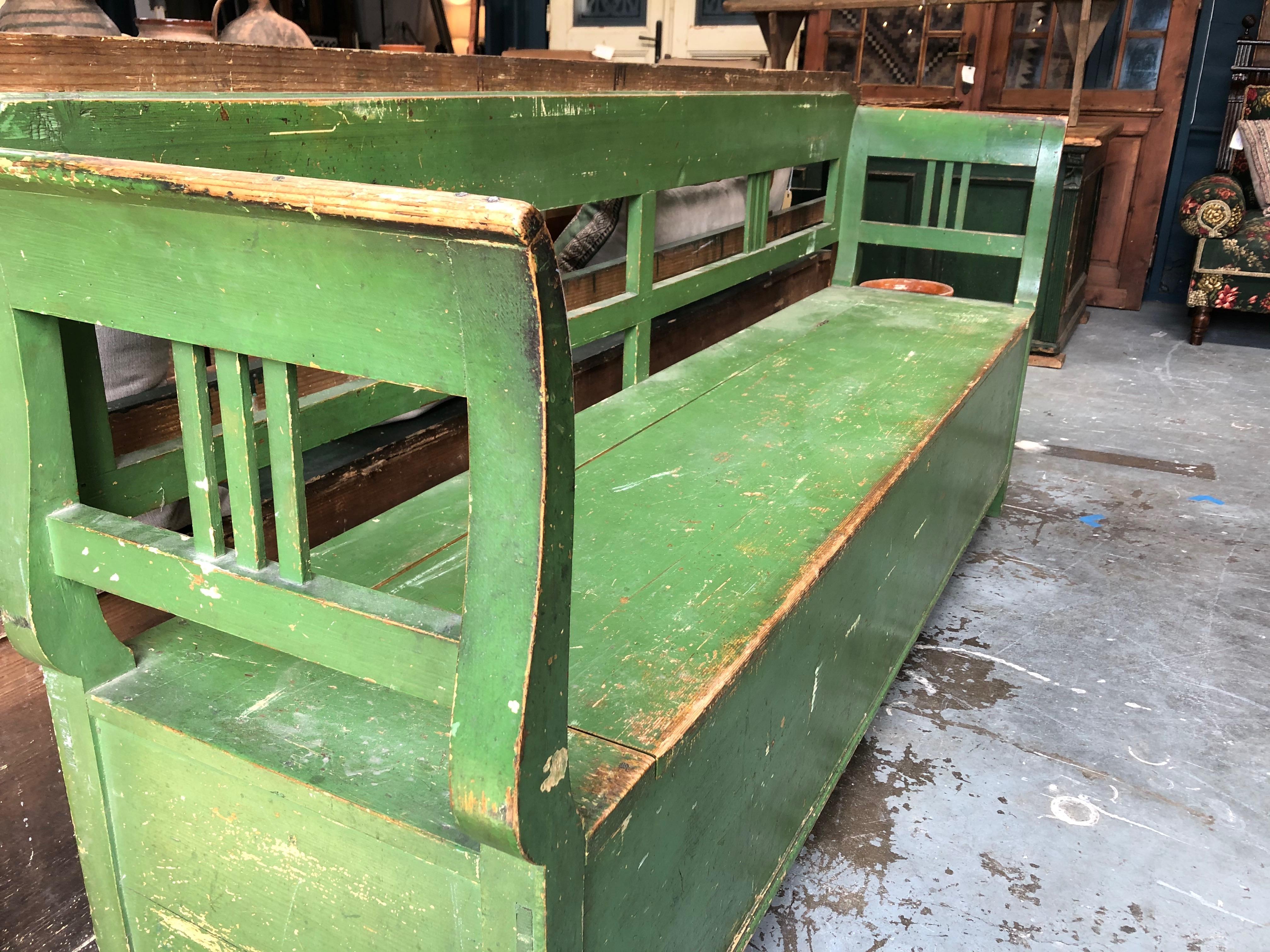This hand painted green bench features a storage unit beneath the seat (see pictures). The item is in good vintage condition and is consistent with age and use. Perfect to place in a hallway or entryway. 
 
Measures: 80” L x 18” D x 35.5” H
Seat