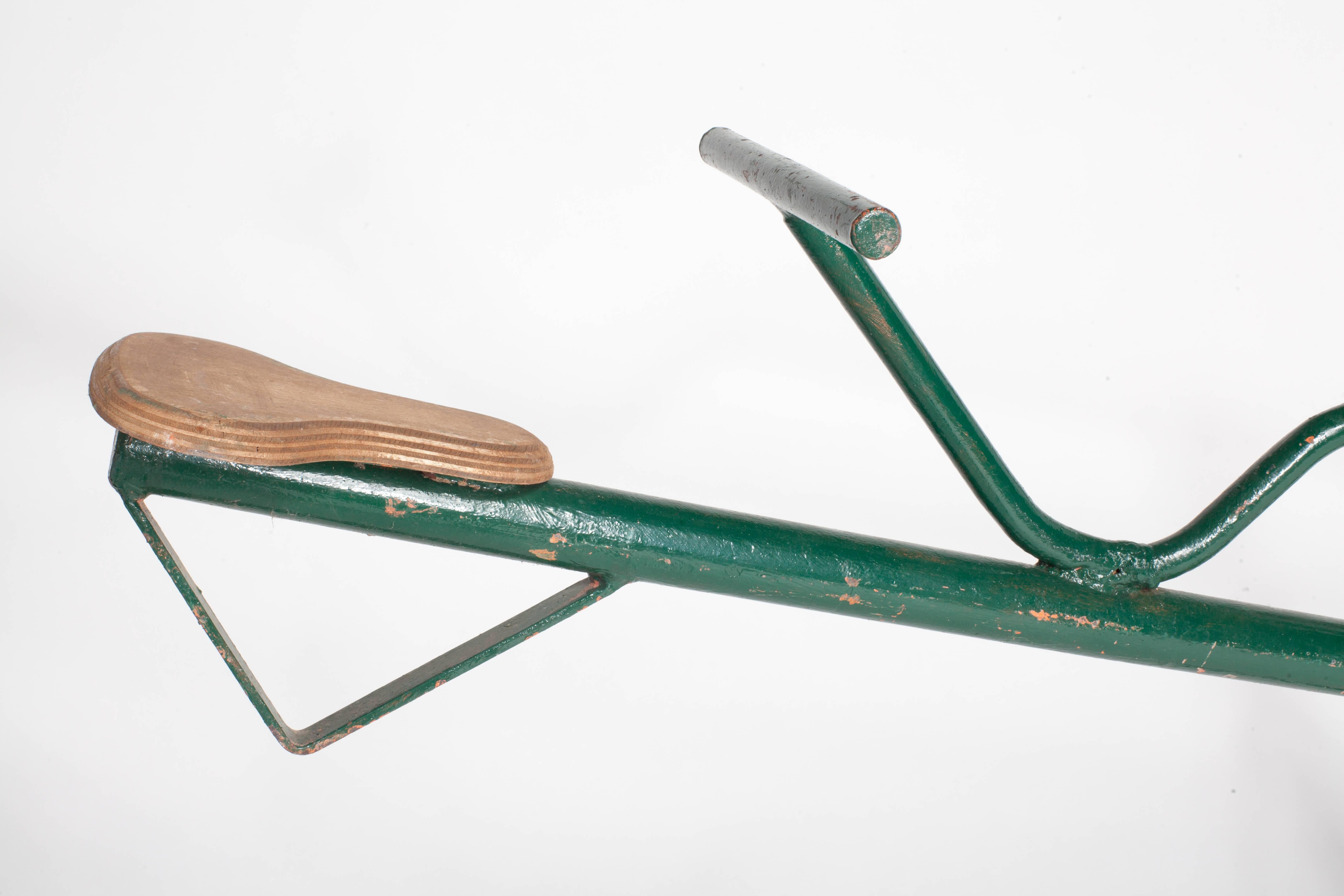 Vintage French green metal see saw with two wooden seats.