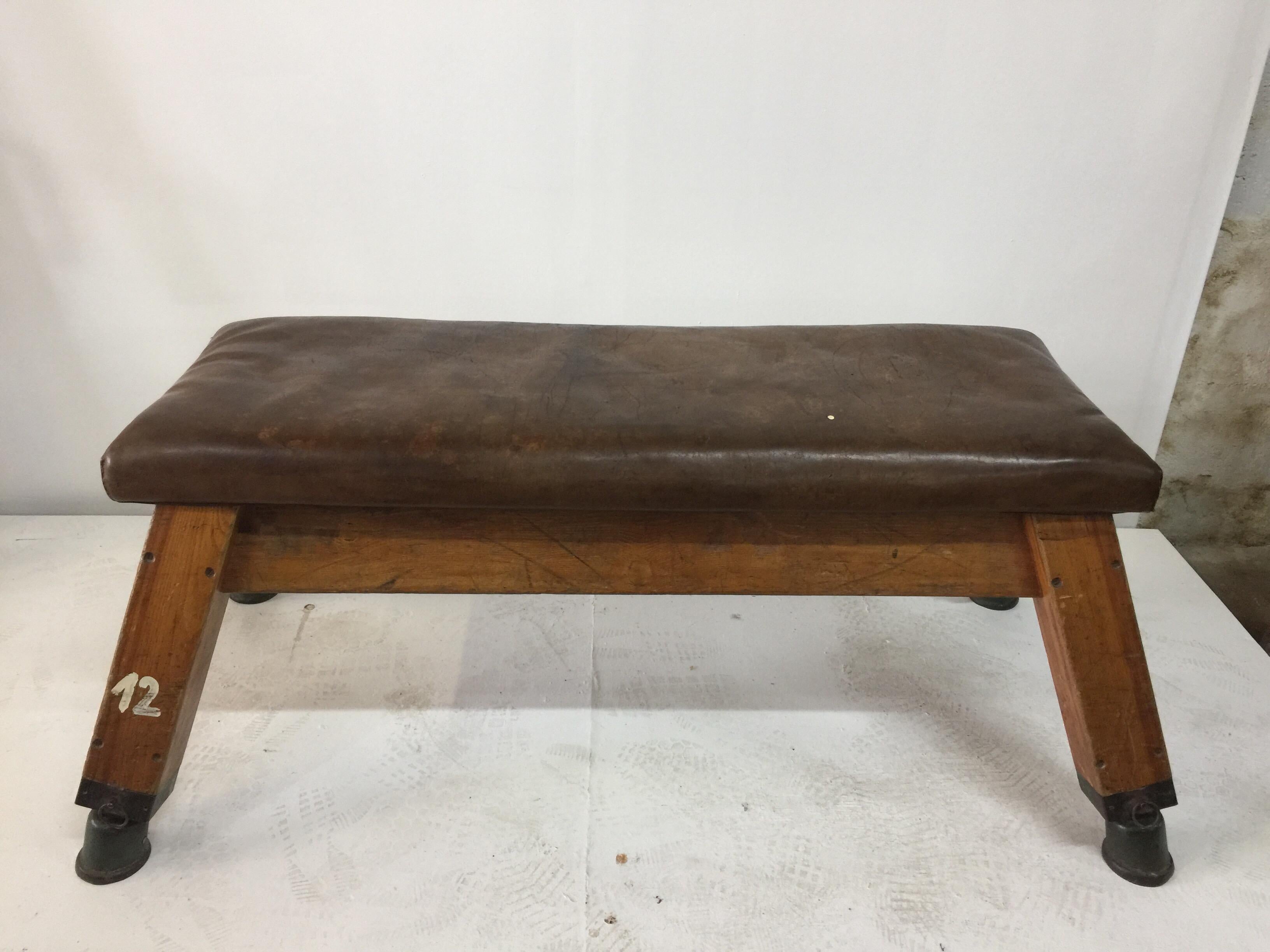 This rare to find European gym bench or table has a thick, worn brown leather top with lots of wear and beauty. Strong and solid! circa 1940s.

Dimensions of leather top only: 52 inches wide, 19 inches deep.