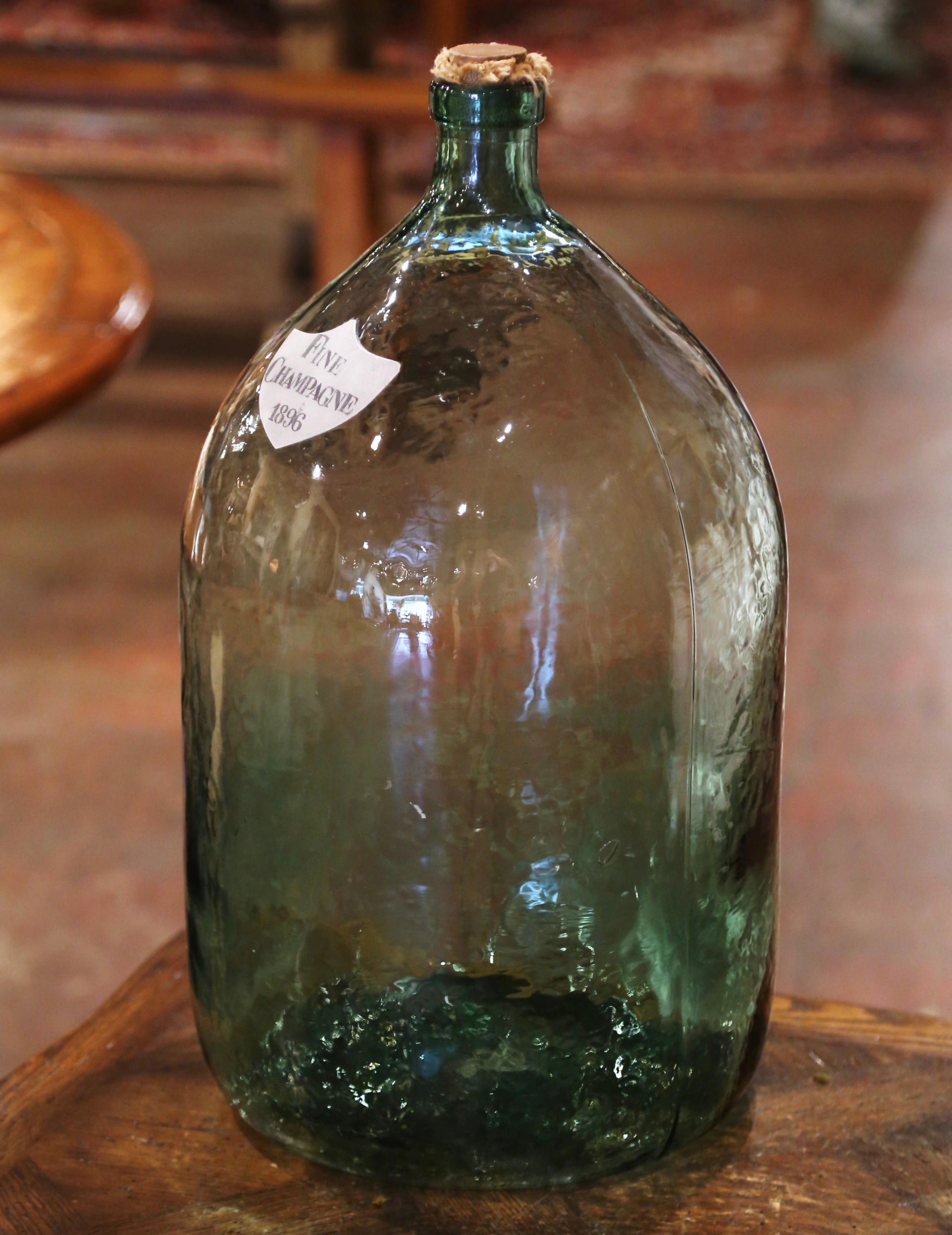 Store your wine corks in this Classic French wine bottle! Hand blown in France, this tall glass bottle with green shade features stamped 