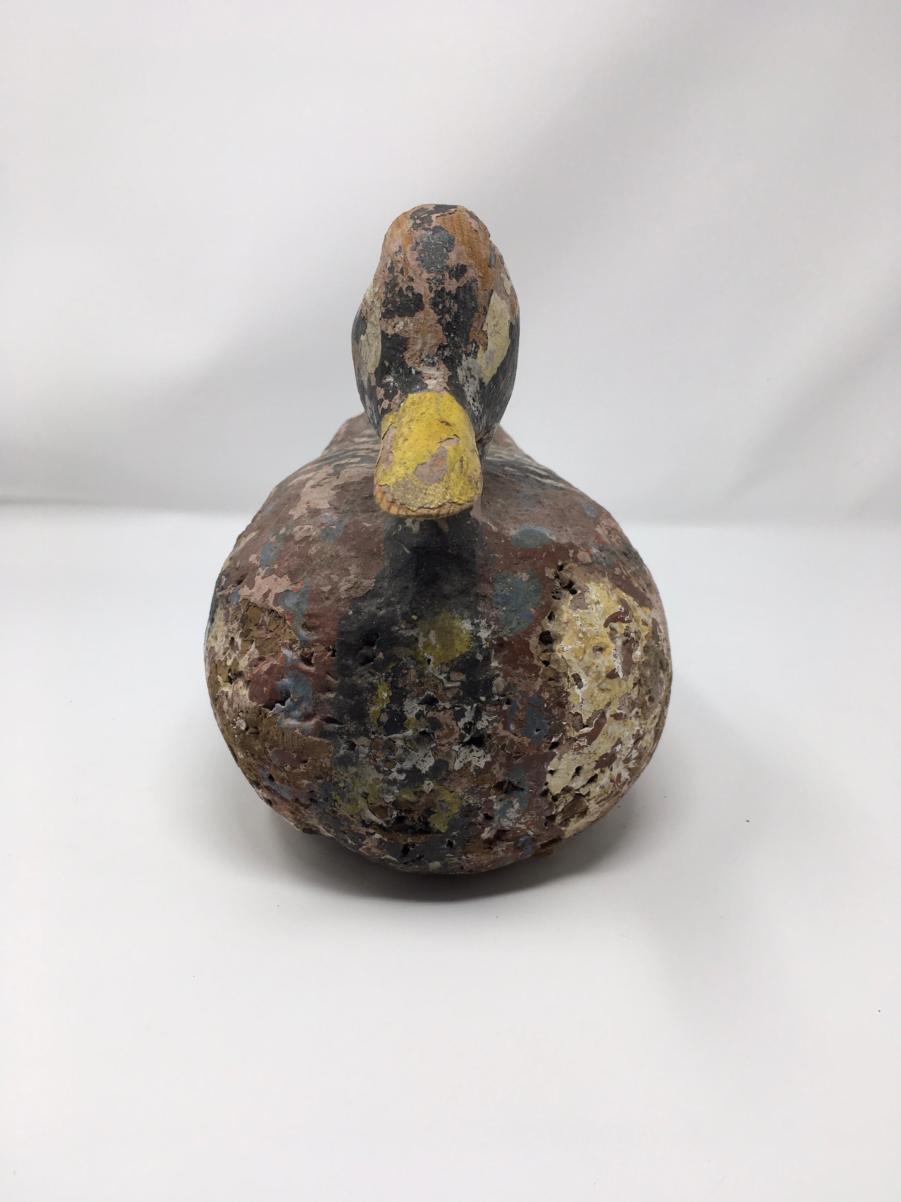 Found in France, this hand carved and painted duck decoy is perfect for the collector or hunter. Well used by a previous hunter, the paint has faded through time, the original detail can still be seen and admired.