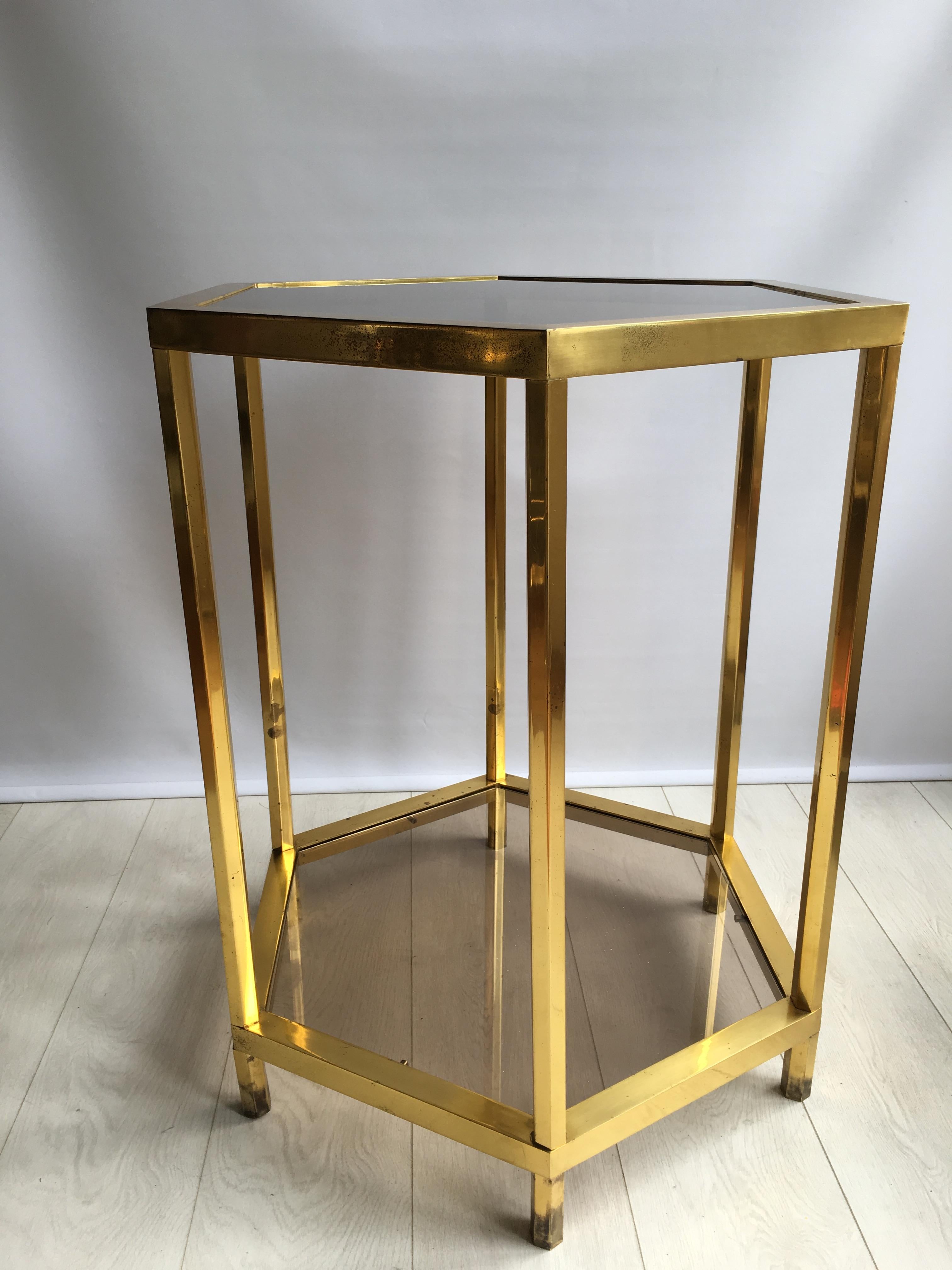 Great shape to this tall centre table measuring 76.5cm.

With smoked glass shelves and patinated brass finish to the frame (please see close up images)