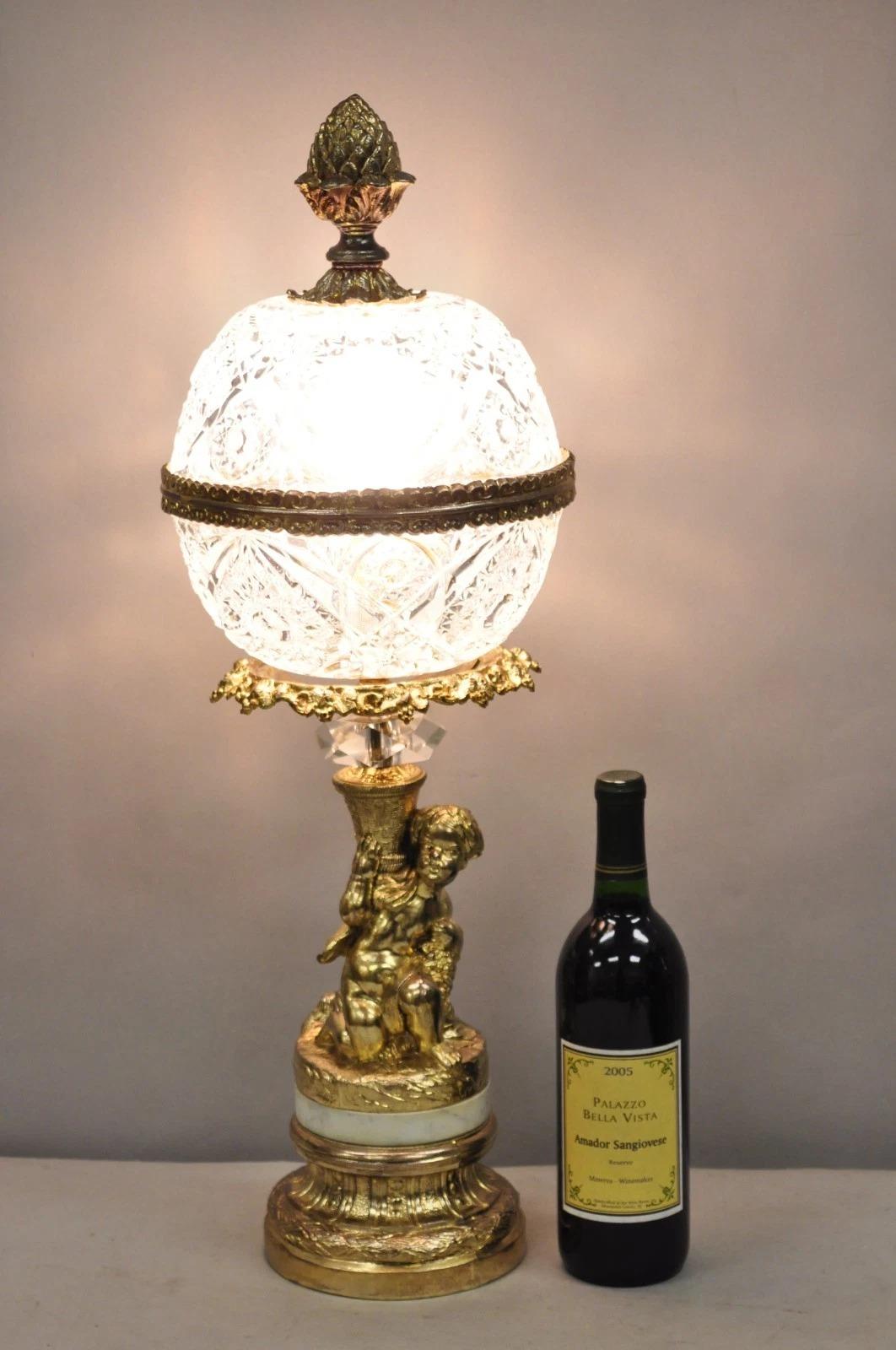 Vintage French Style Hollywood Regency Gold Gilt Metal Cherub Crystal Glass Globe Table Lamp. Circa Mid 20th Century. Dimensions : 27