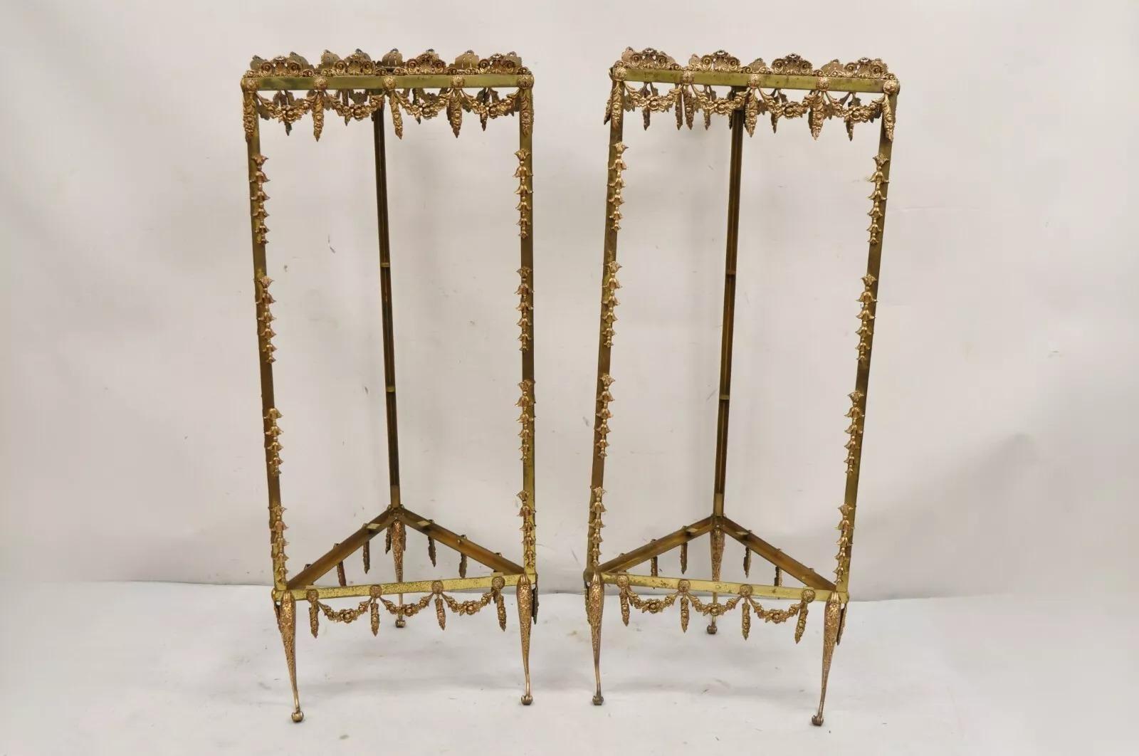 Vintage French Hollywood Regency Ornate Brass Curio Triangular Etagere Stands - a Pair. Pair features ornate drape form ormolu throughout, 3 shapely cabriole legs, unique triangular form, stamped 