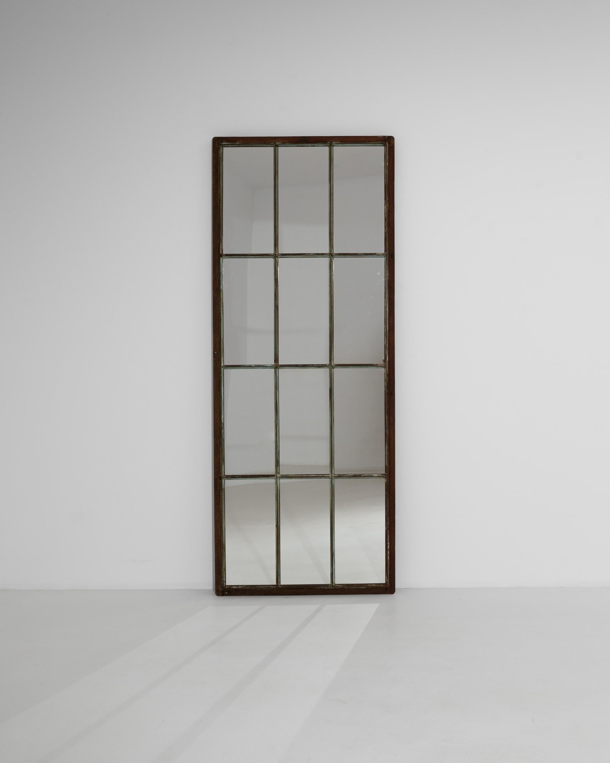 Originally used as factory windows, the long proportions and stripped back simplicity of this vintage mirror makes for a unique Industrial accent. Made in 20th century France, the grid-like form mimics a mullioned window, while the large proportions