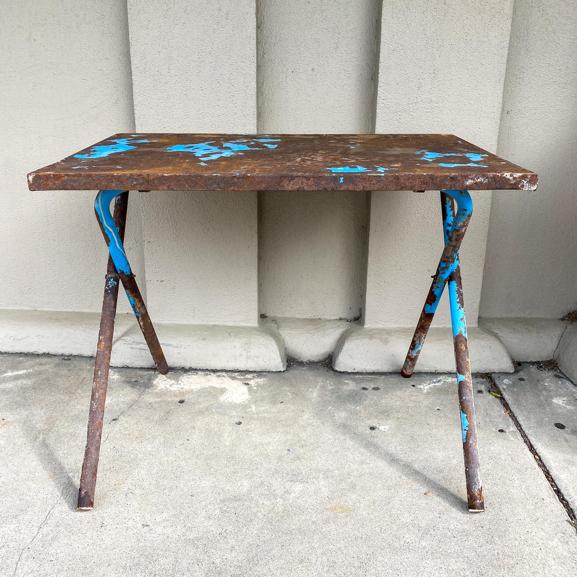 This industrial folding table was sourced in France and is so beautifully rusted, we love the look of this piece as a garden console or outdoor table. The legs and top were once painted an electric blue, and some of that paint remains... the legs