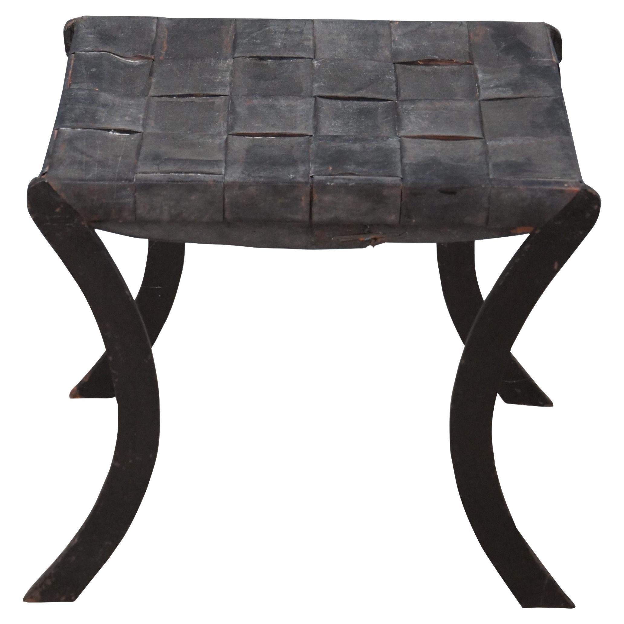 An intriguing French Iron stool, circa mid 20th century.  Features an iron frame with saber legs and a woven leather seat.  

Dimensions:

20.5