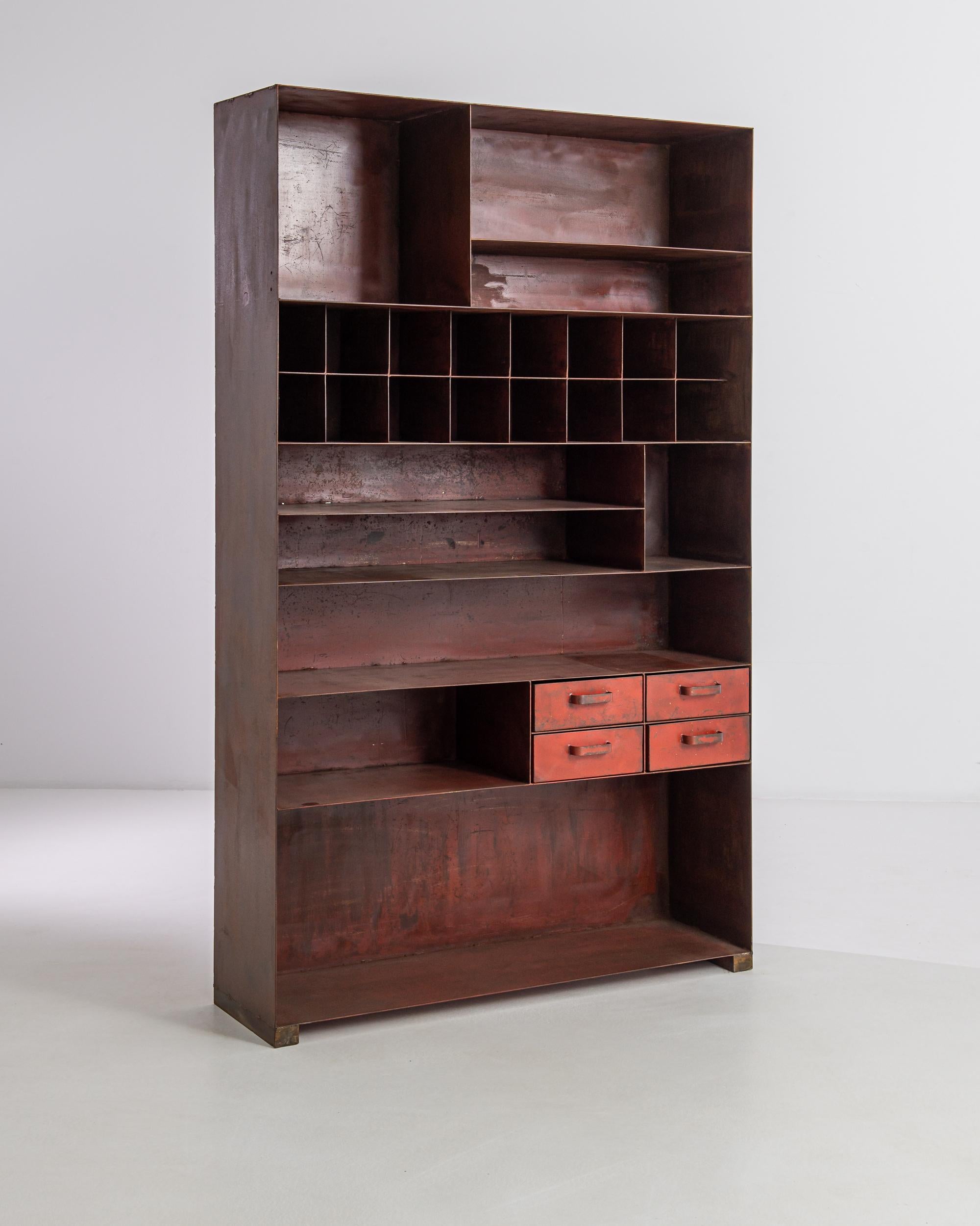 This intriguing vintage metal cabinet offers a rich interpretation of the industrial aesthetic. Sourced from France, a host of different sized compartments creates a lively sense of variation and asymmetric order, inviting an array of organizational