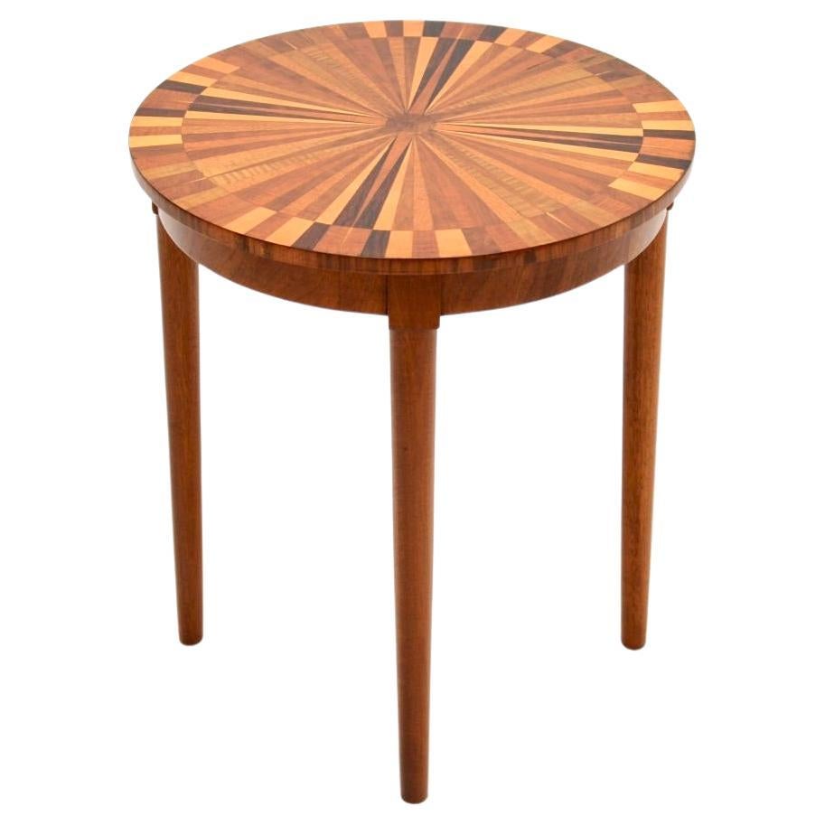 A stunning vintage French inlaid starburst side table, dating from around the 1950’s.

This is of lovely quality and has an absolutely stunning starburst design on the circular top, inlaid with many different types of wood. It stands on beautifully
