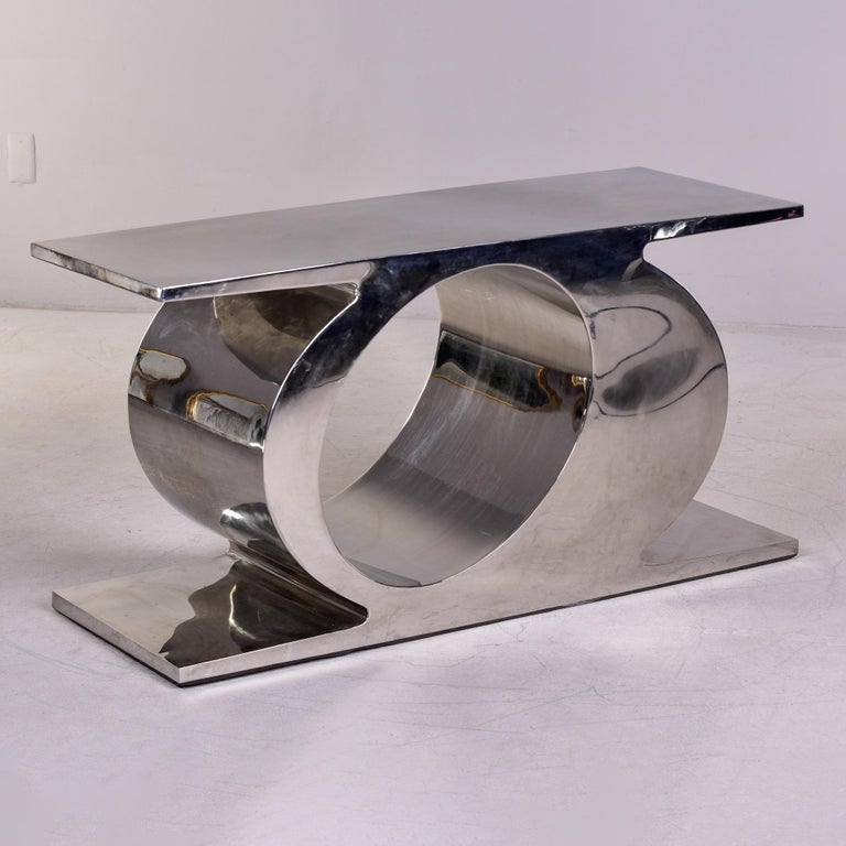 Found in Paris, this circa 1990s inox steel sofa table or console has a sculptural quality to the base. Table top length could be extended by adding a glass top. Unknown maker. Very good vintage condition with minor scattered surface wear to steel.