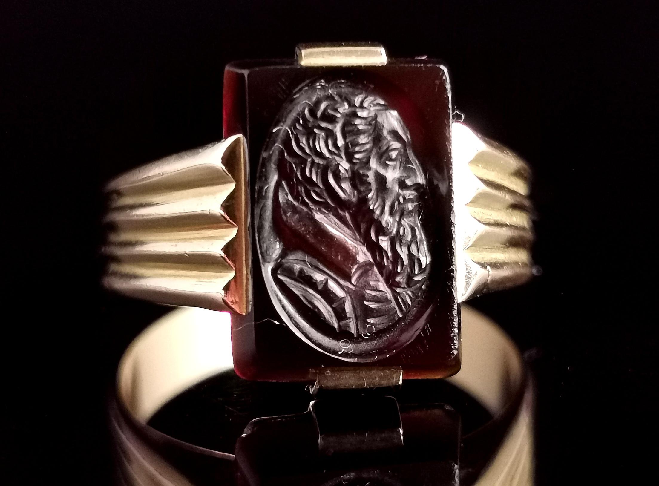 A handsome and unusual French vintage intaglio ring.

Crafted in rich 9kt gold the ring has chunky raised shoulders and a bevelled design band.

To the front there is a carved glass intaglio panel, very finely carved with the profile of a bearded