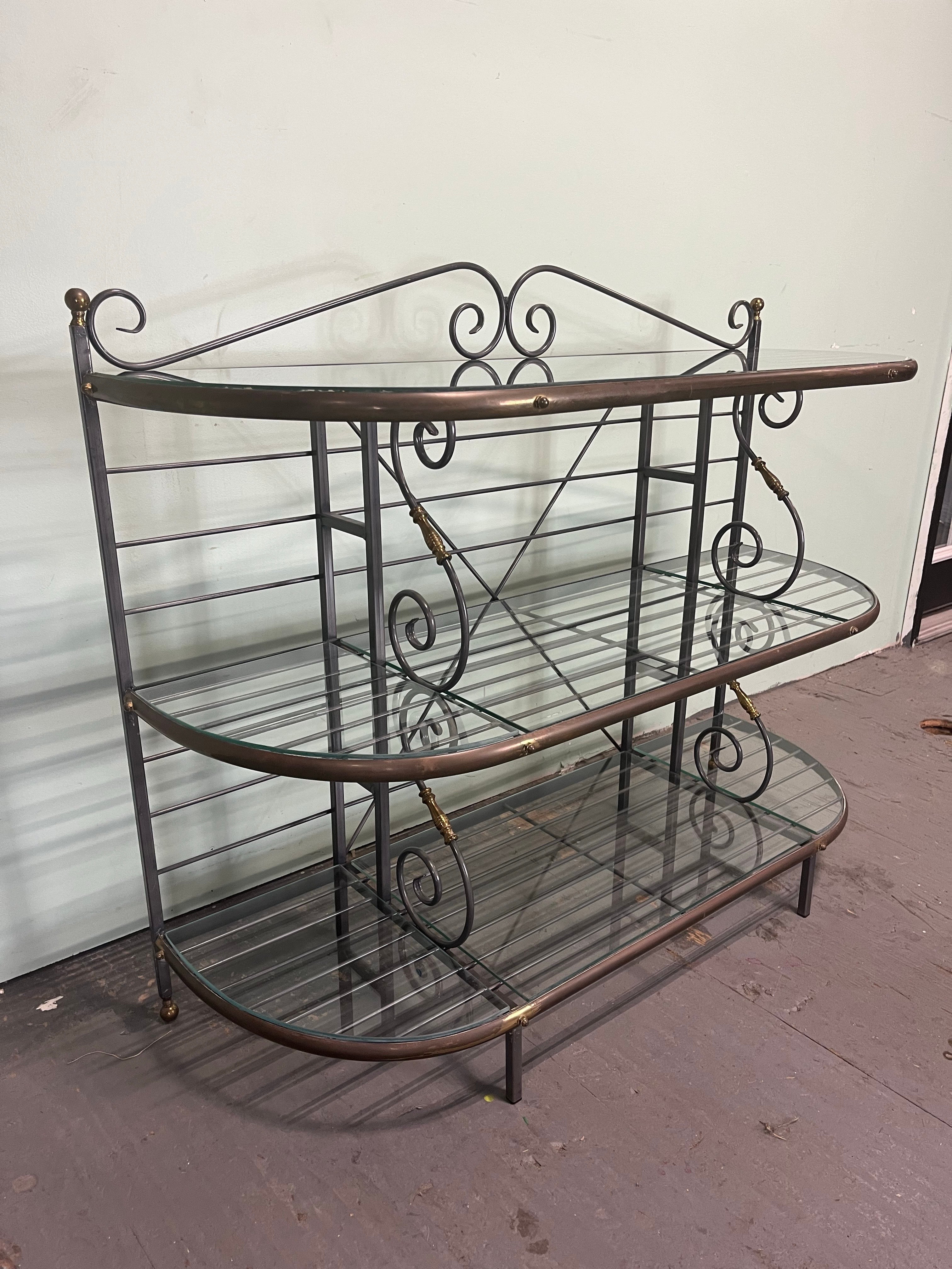 Unique low profile French Baker's Rack. Iron and Brass with 3 tiers of glass lined shelving. A lot of surface space for ample storage.