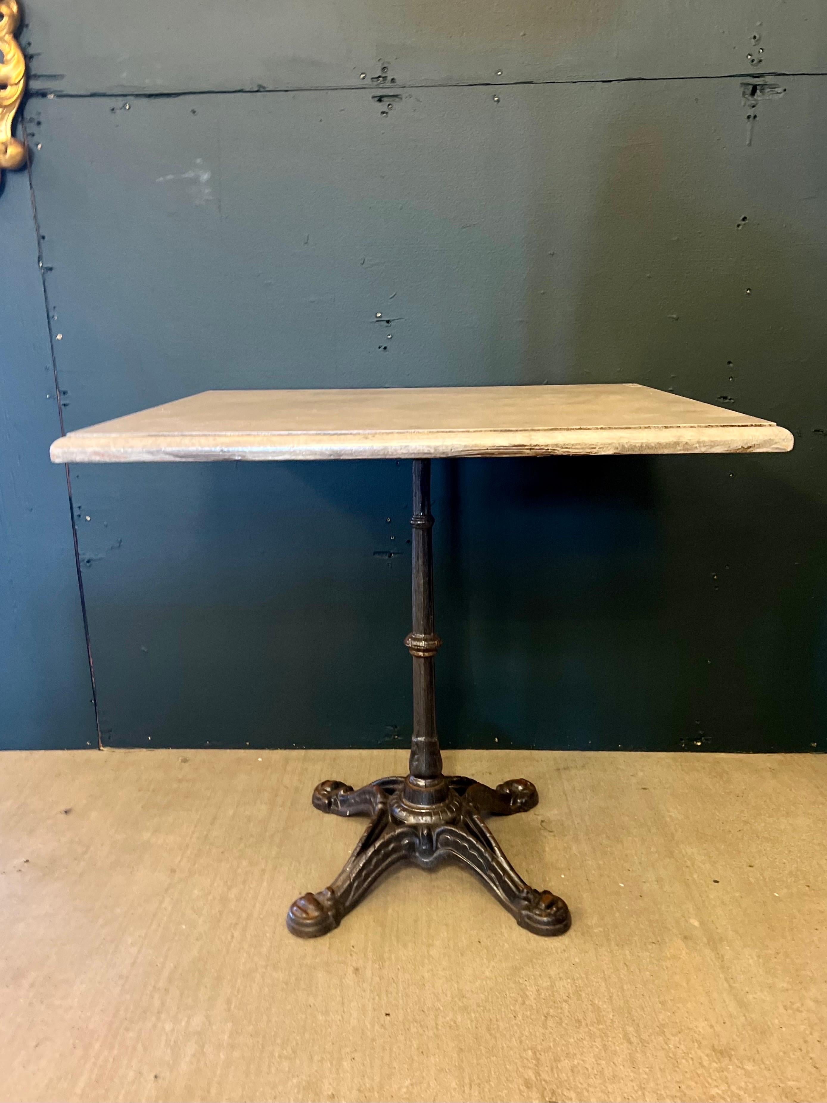 Vintage French iron bistro table with a solidly built wood top with beveled edge and painted in a faux marble finish. Wood top is removable for transport and these French bistro tables can be used both indoor & outdoor. Multiple tables available