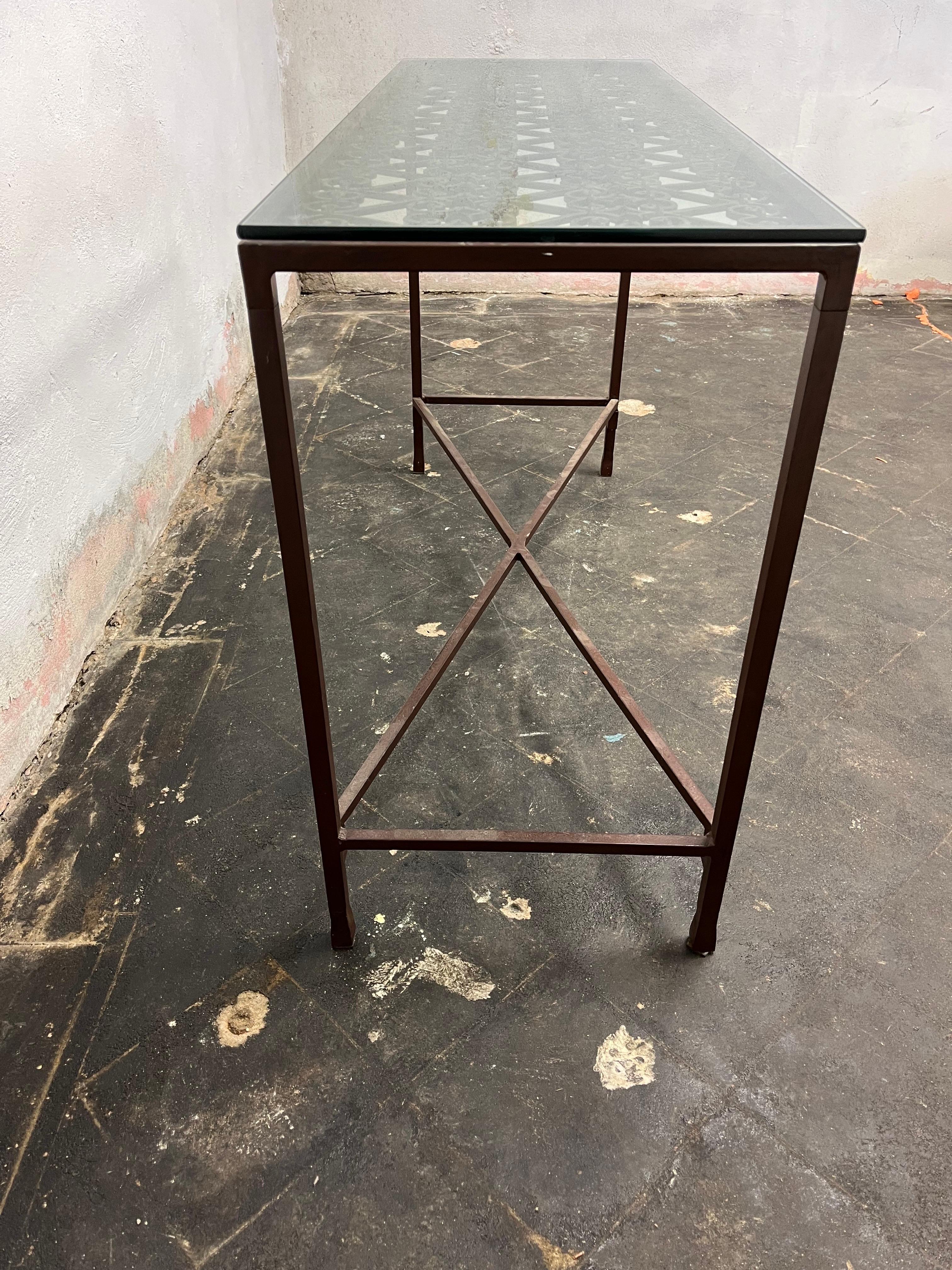Sophisticated glass top console with iron scrolled gate top. Slender tapered legs with x base stretcher that sits in leg holes to allow for leveling. Nice aesthetic.
Curbside to NYC/Philly $300