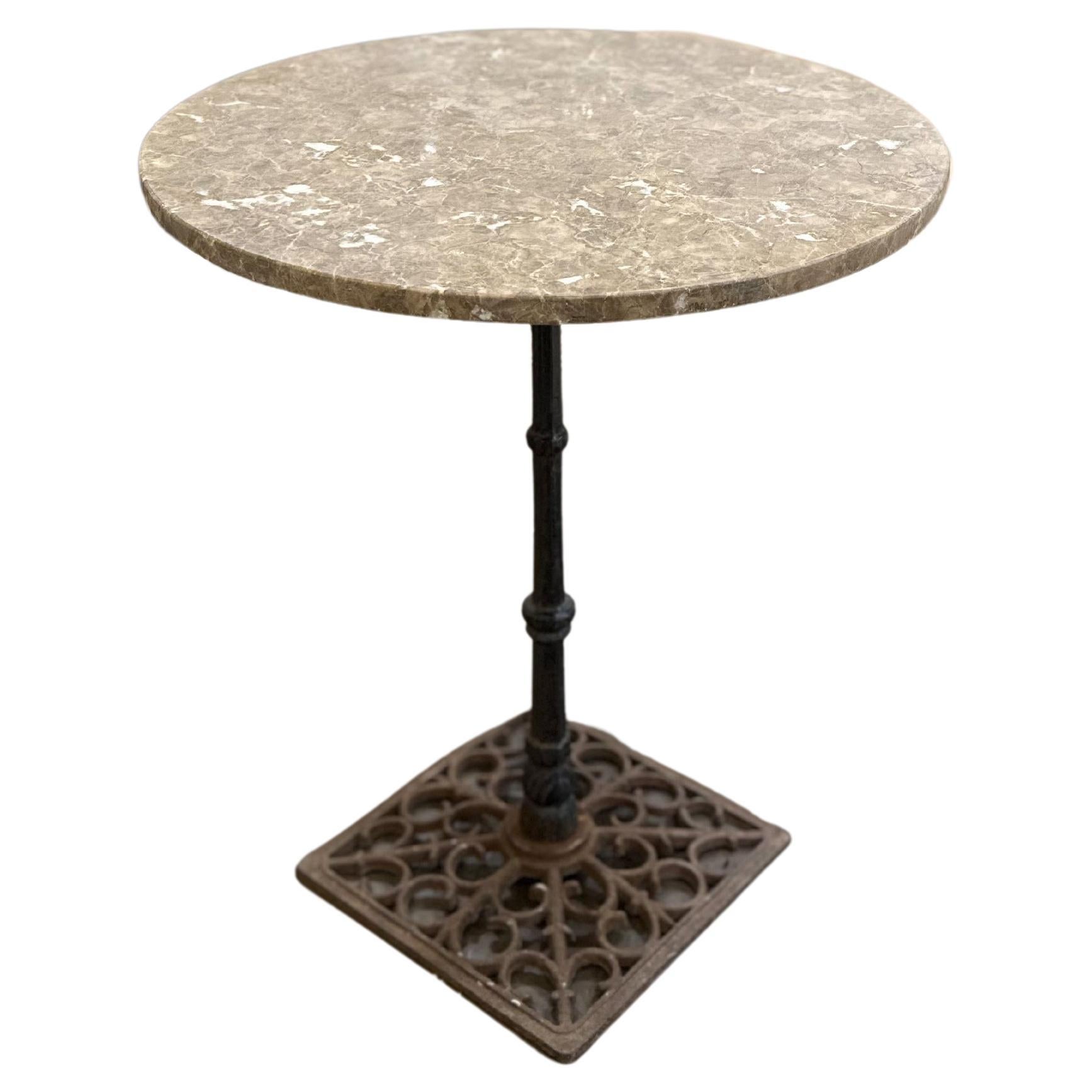 Recently discovered during our time in Northern France, this heavy French iron bistro table is topped with a 24 inch marble top. The iron detail in the base is quite beautiful and the solid marble top includes creamy greys and white coloring.